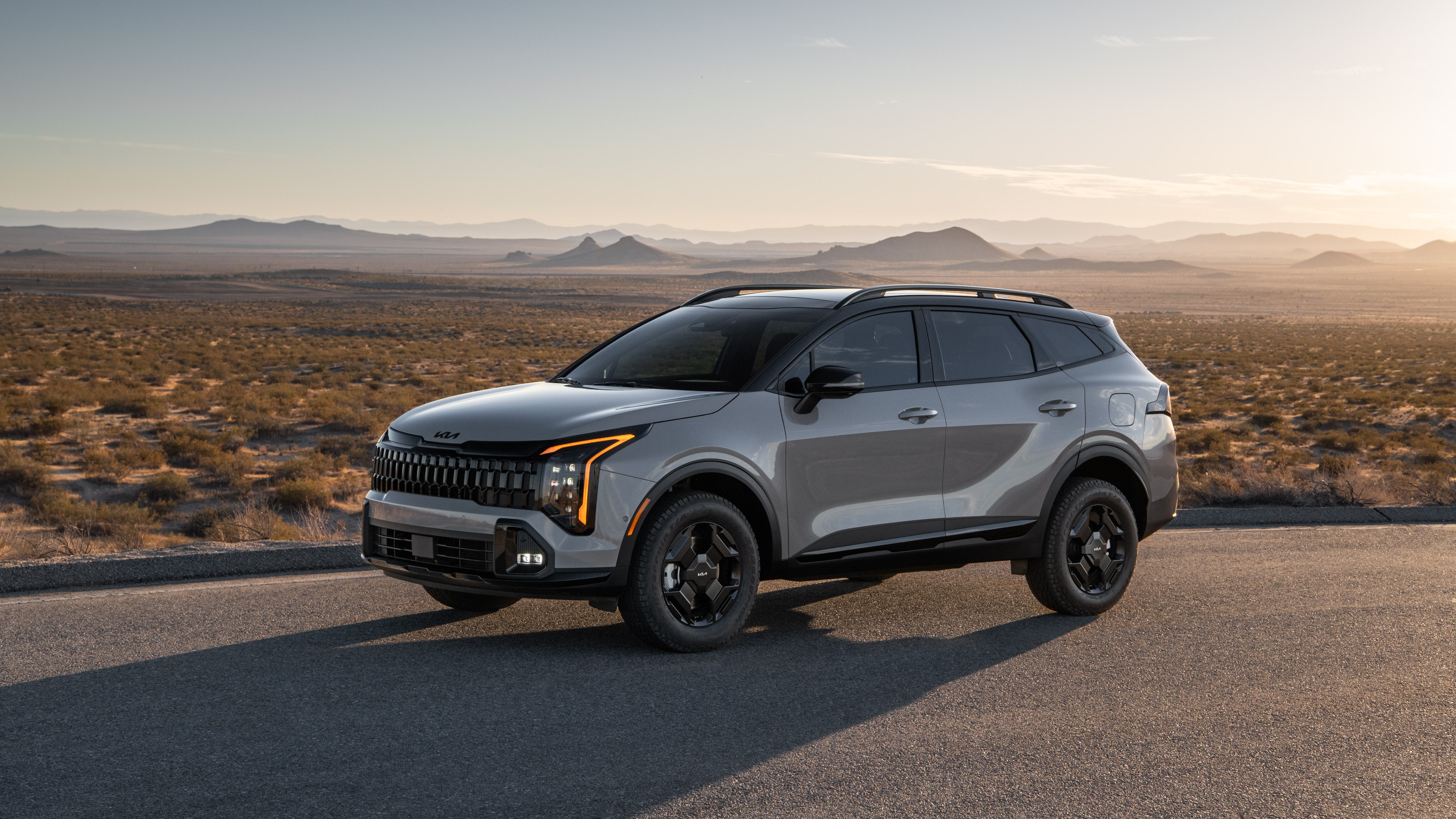 2027 Kia Sportage X-Line, front three-quarter view, parked in the desert