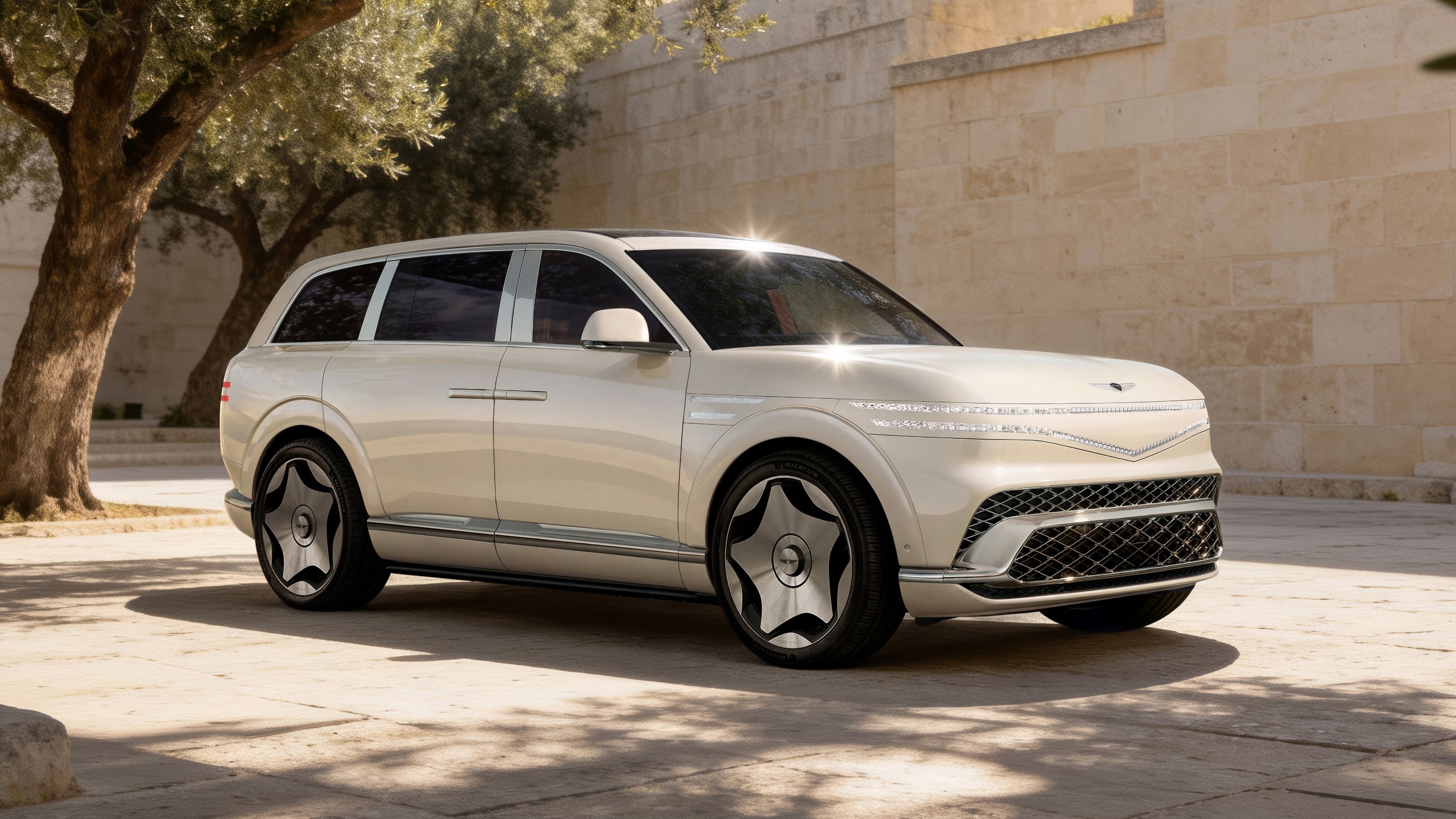 Cream Genesis GV90 Neolun electric SUV parked in a stone courtyard