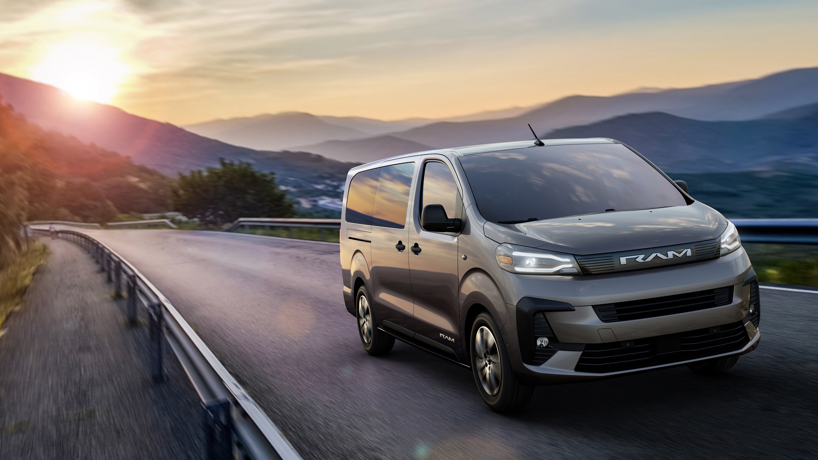 2027 Ram ProMaster City passenger wagon driving on a mountain road at sunset