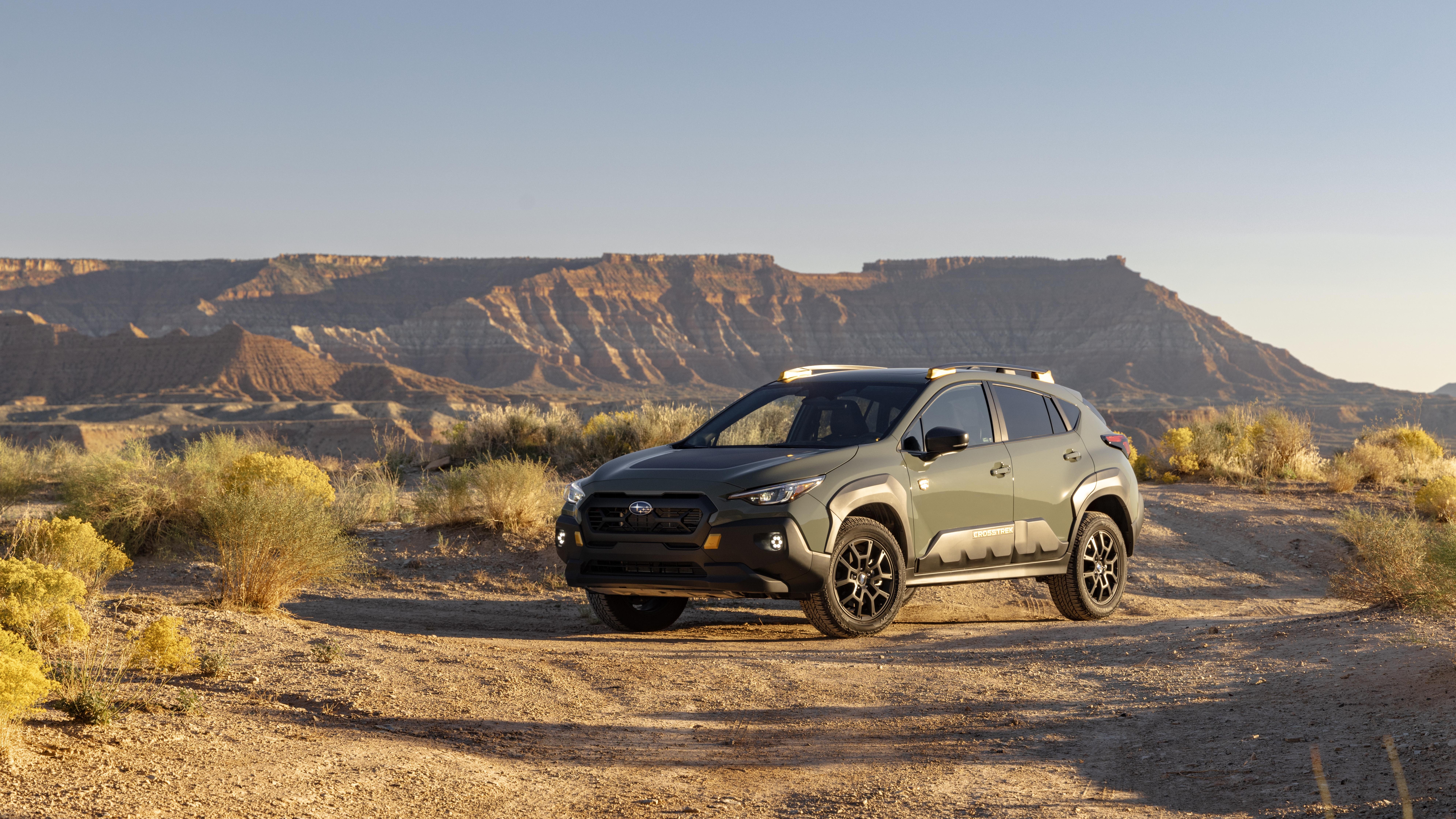 Green Subaru Crosstrek Wilderness parked on a desert trail