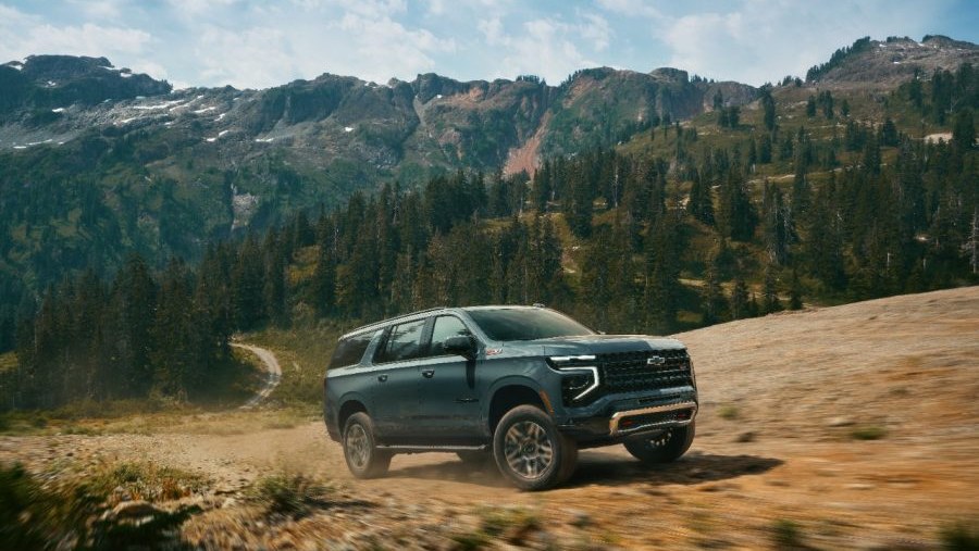 2026 Chevrolet Suburban Z71 driving on a mountain dirt trail