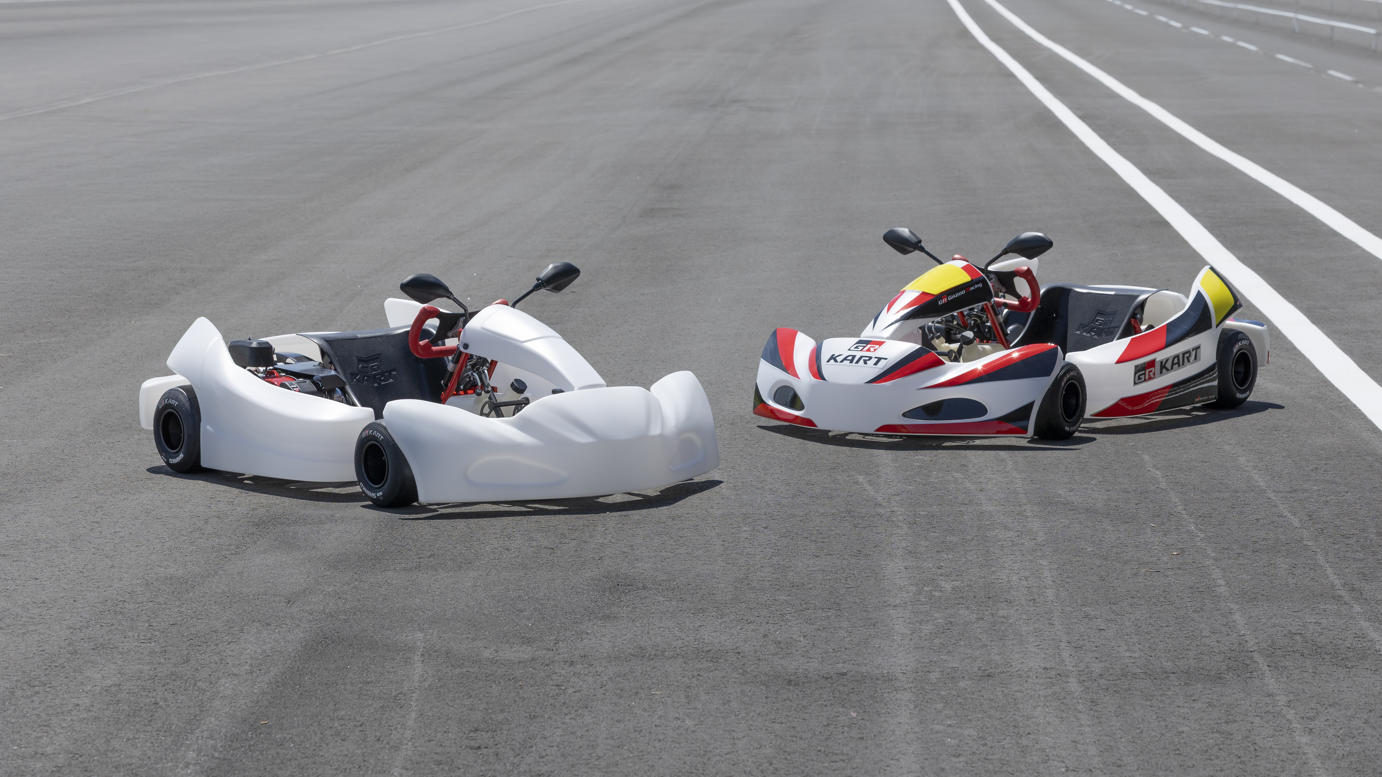 Toyota GR Kart in white and GR livery parked on a race track