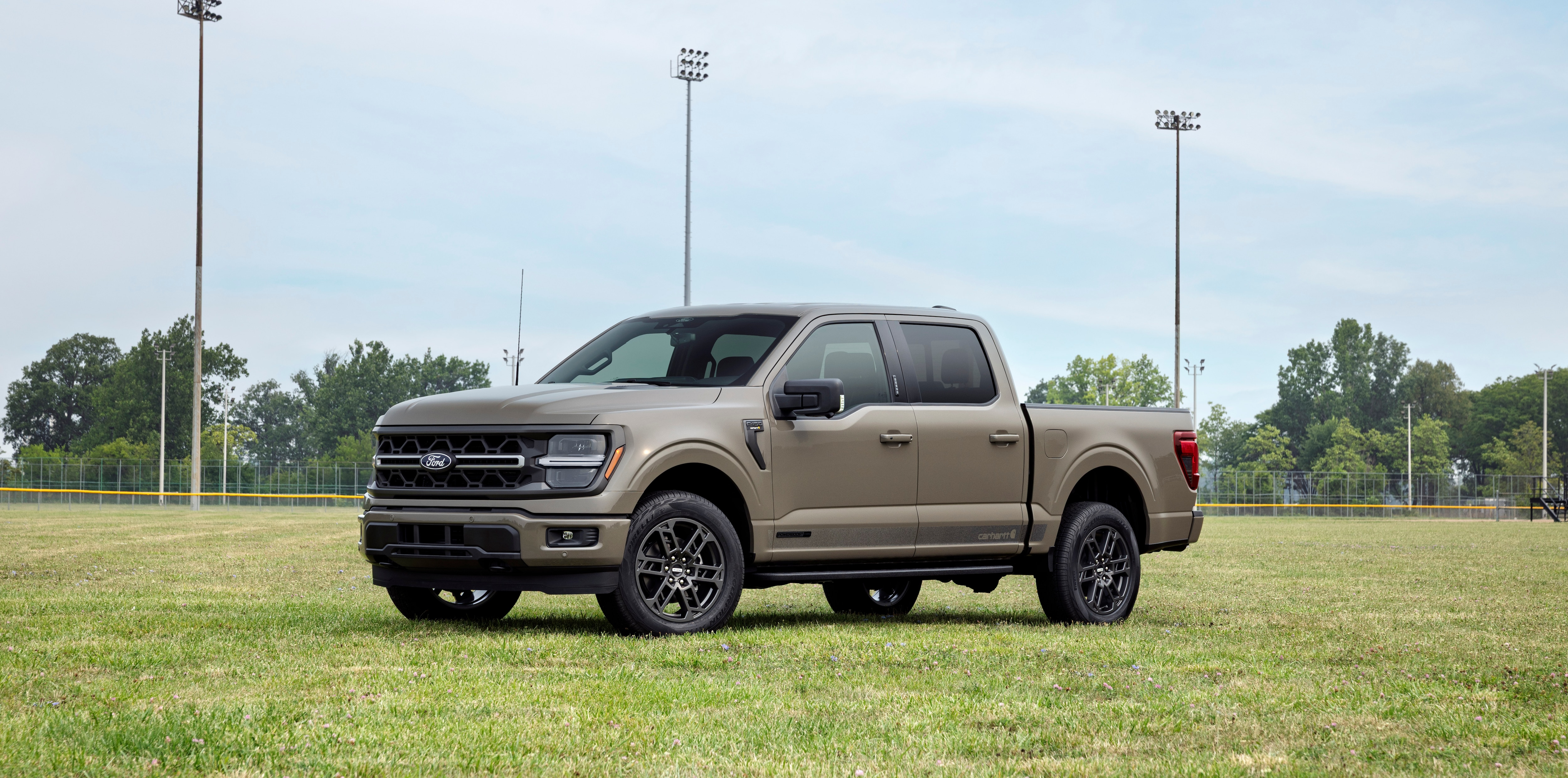 2027 Ford F-150 Carhartt front three-quarter view parked on a ballfield