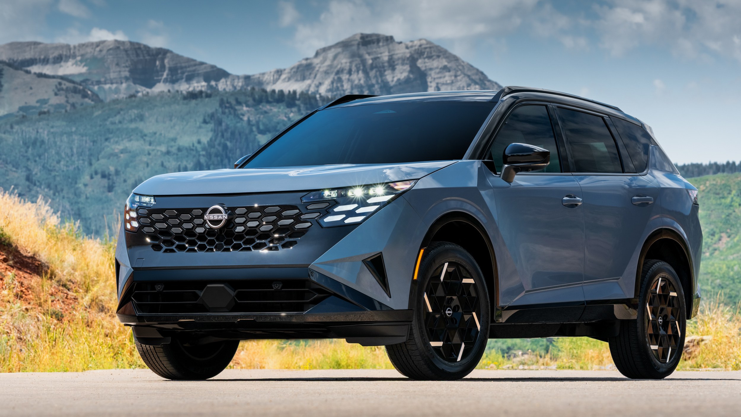 2027 Nissan Rogue Hybrid front three-quarter view in blue with black roof