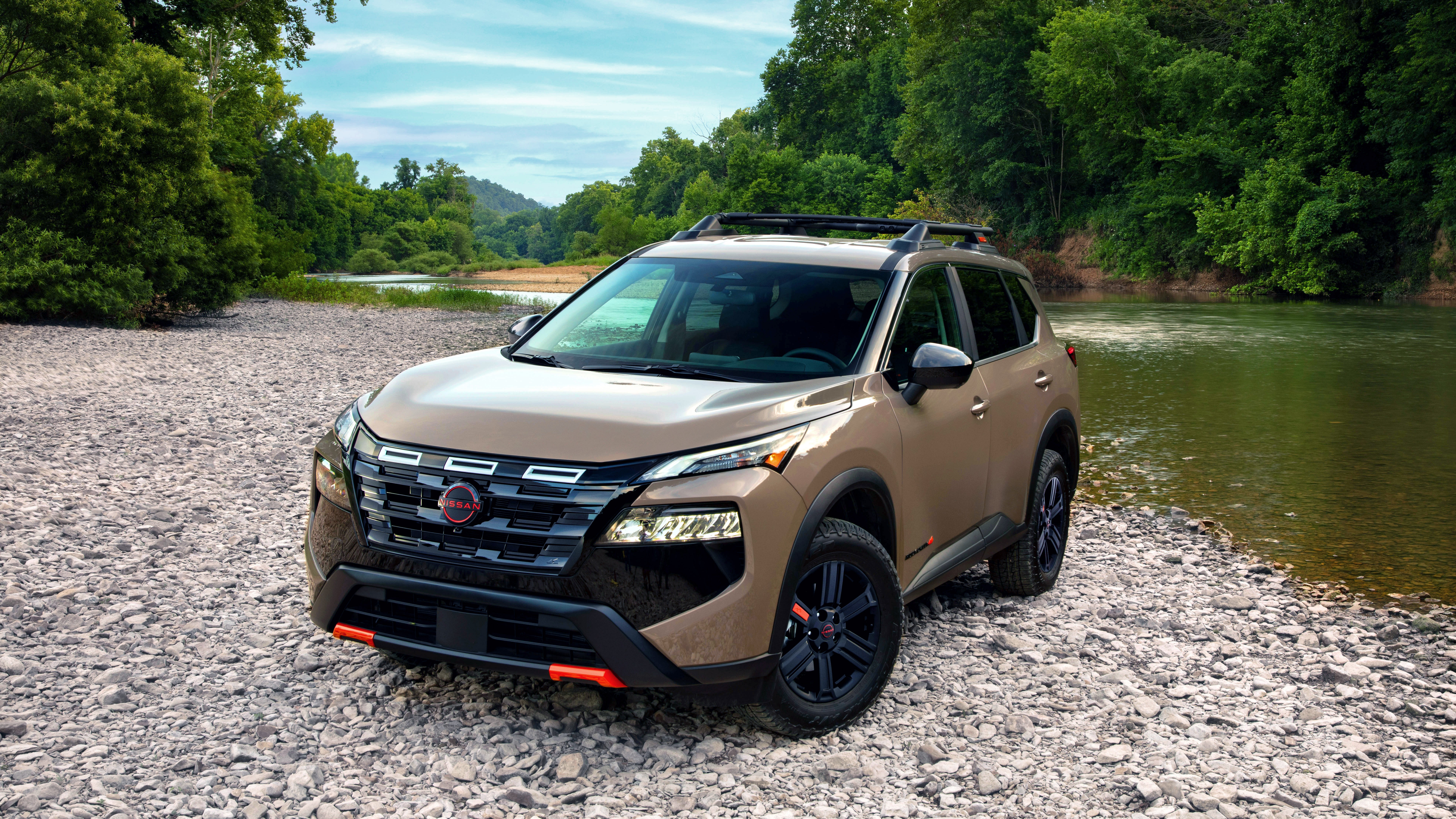 2027 Nissan Rogue Rock Creek parked on a riverbank