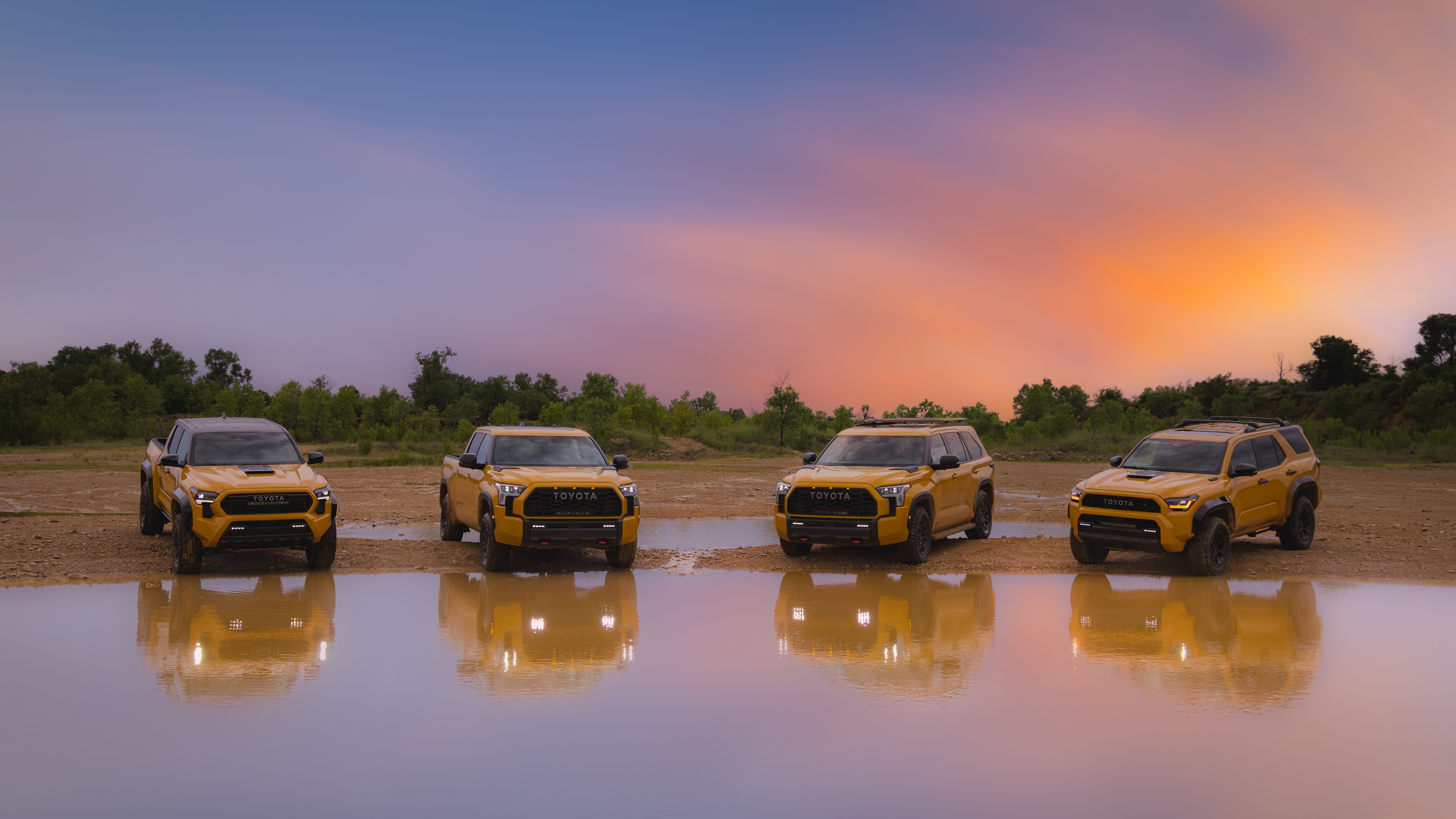 2027 Toyota TRD Pro lineup in Honeycomb and Hot Honey at sunset
