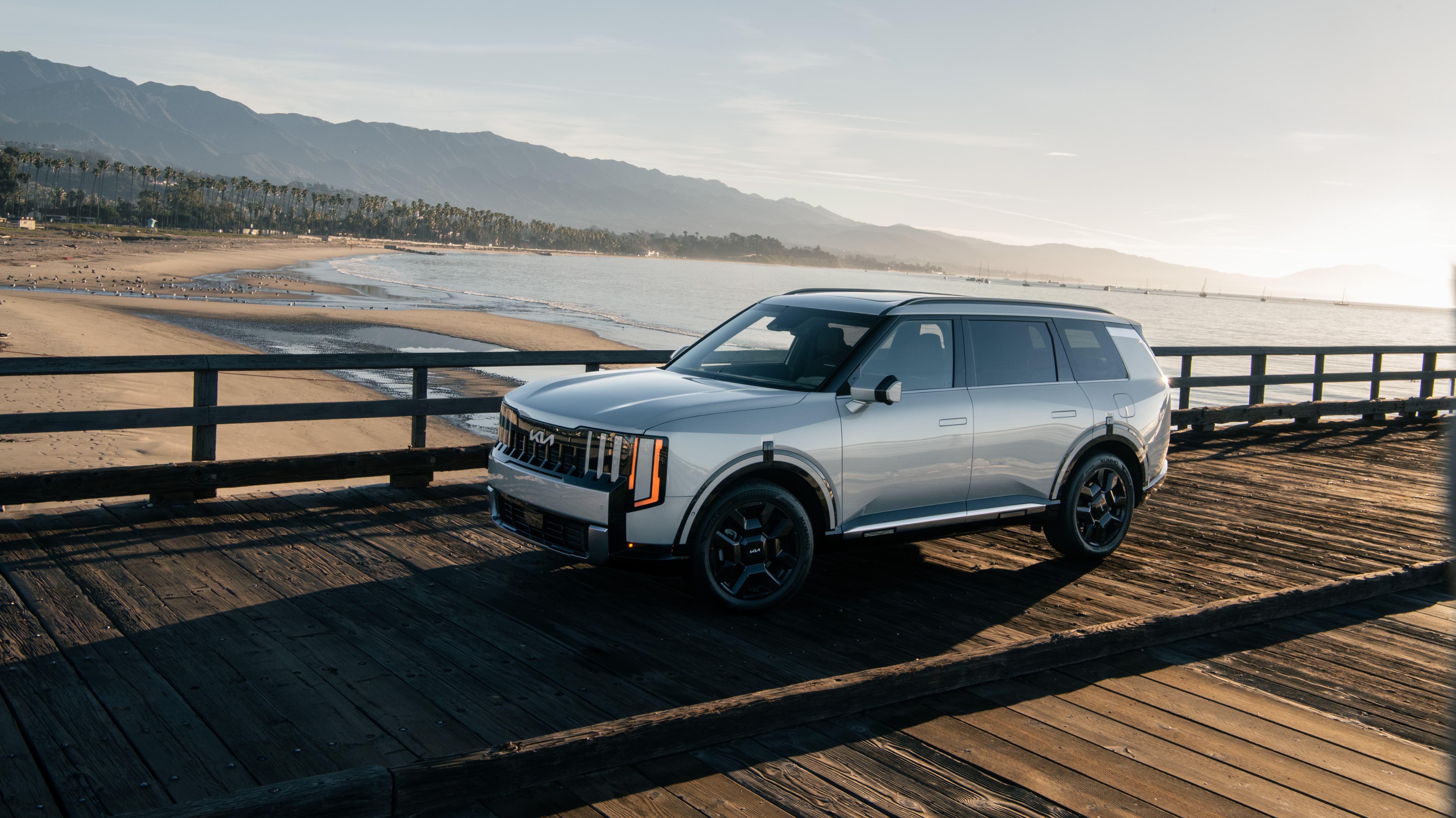 2027 Kia Telluride Hybrid SX-Prestige parked on a wooden pier by the ocean