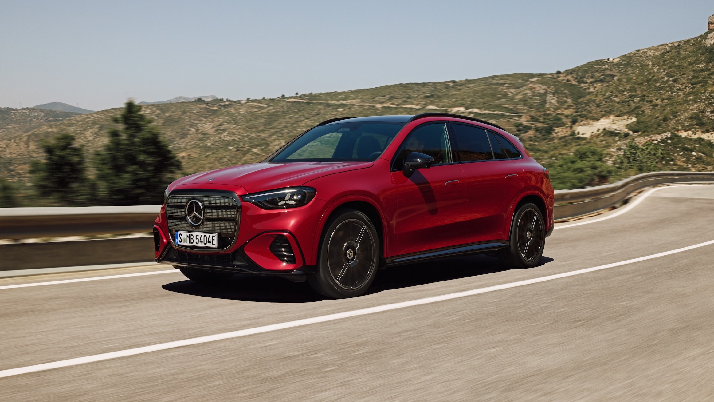 Red 2027 Mercedes-Benz GLC 400 4MATIC Electric driving on a mountain road