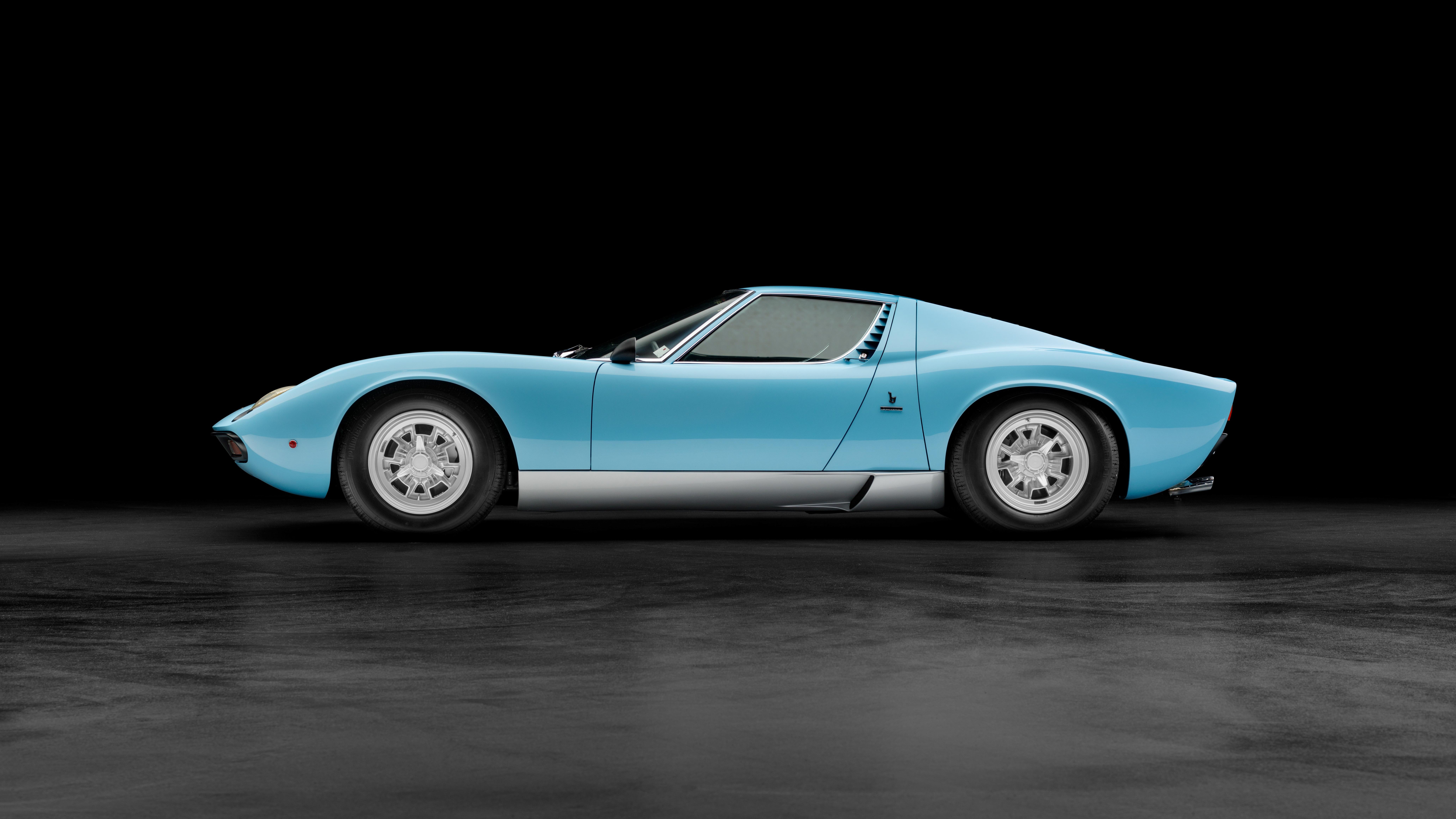 Light blue Lamborghini Miura SV side profile on dark background