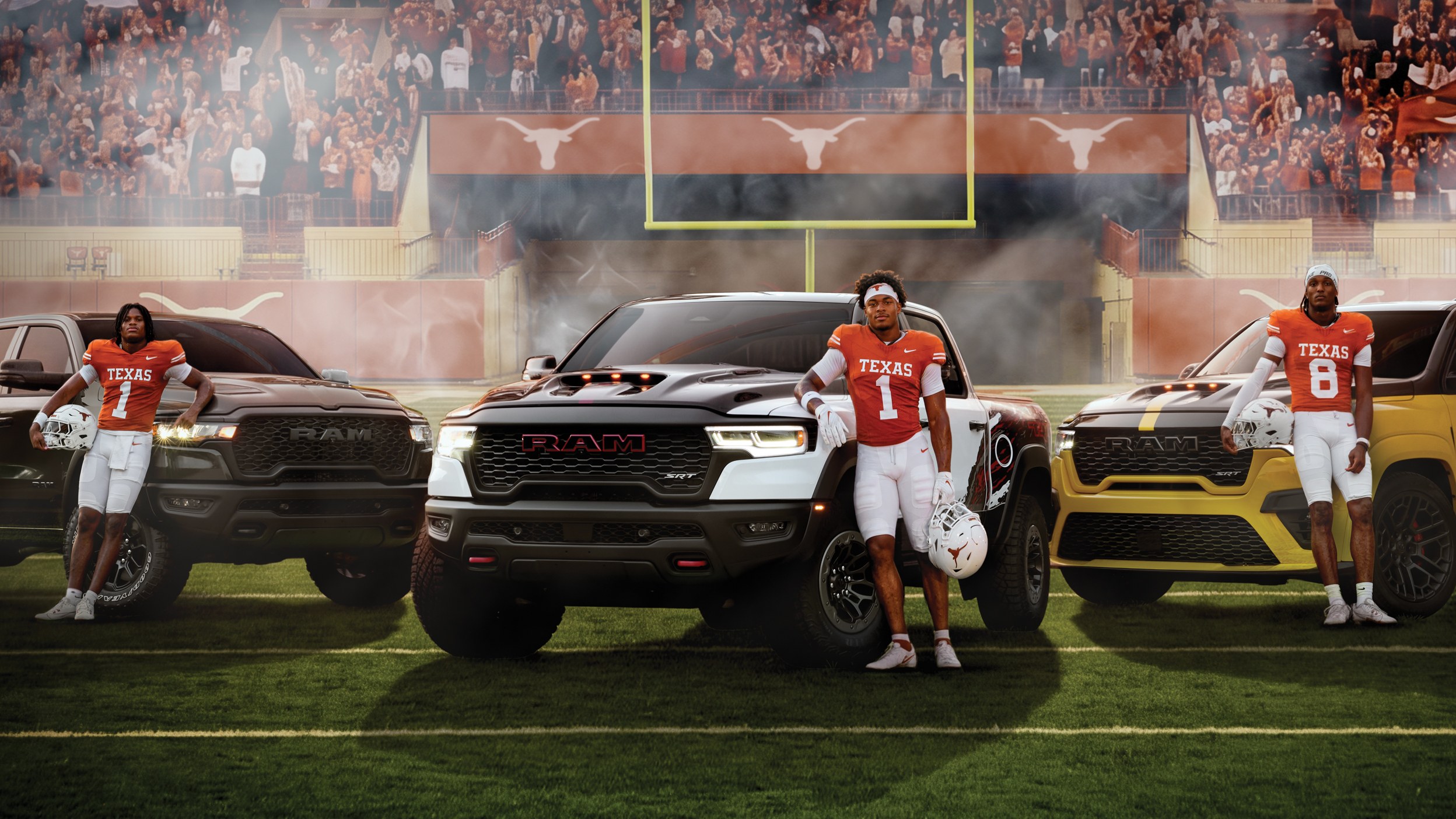 Texas Longhorns players posing with three Ram 1500 pickups on a football field