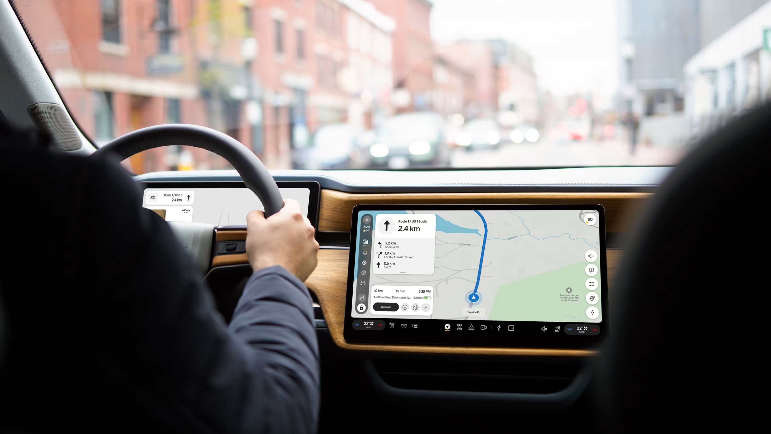 Driver's view in a Rivian R1 with turn-by-turn navigation on the center display