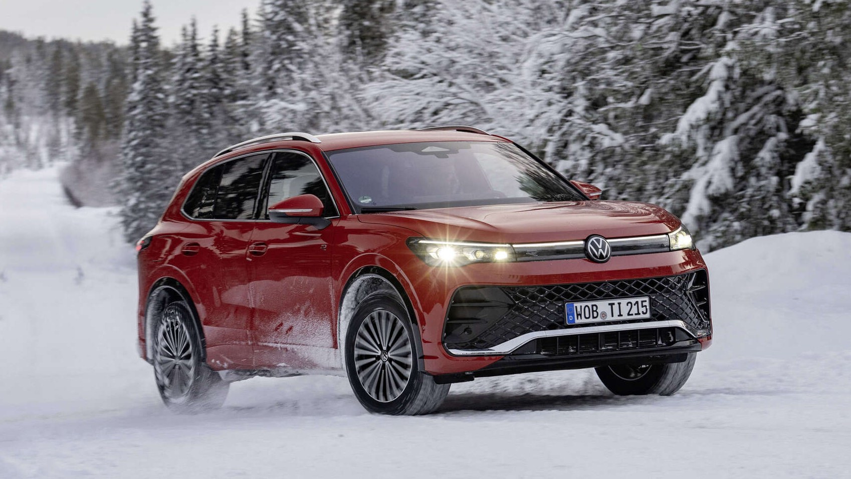 Red third-generation Volkswagen Tiguan front three-quarter view on snowy road