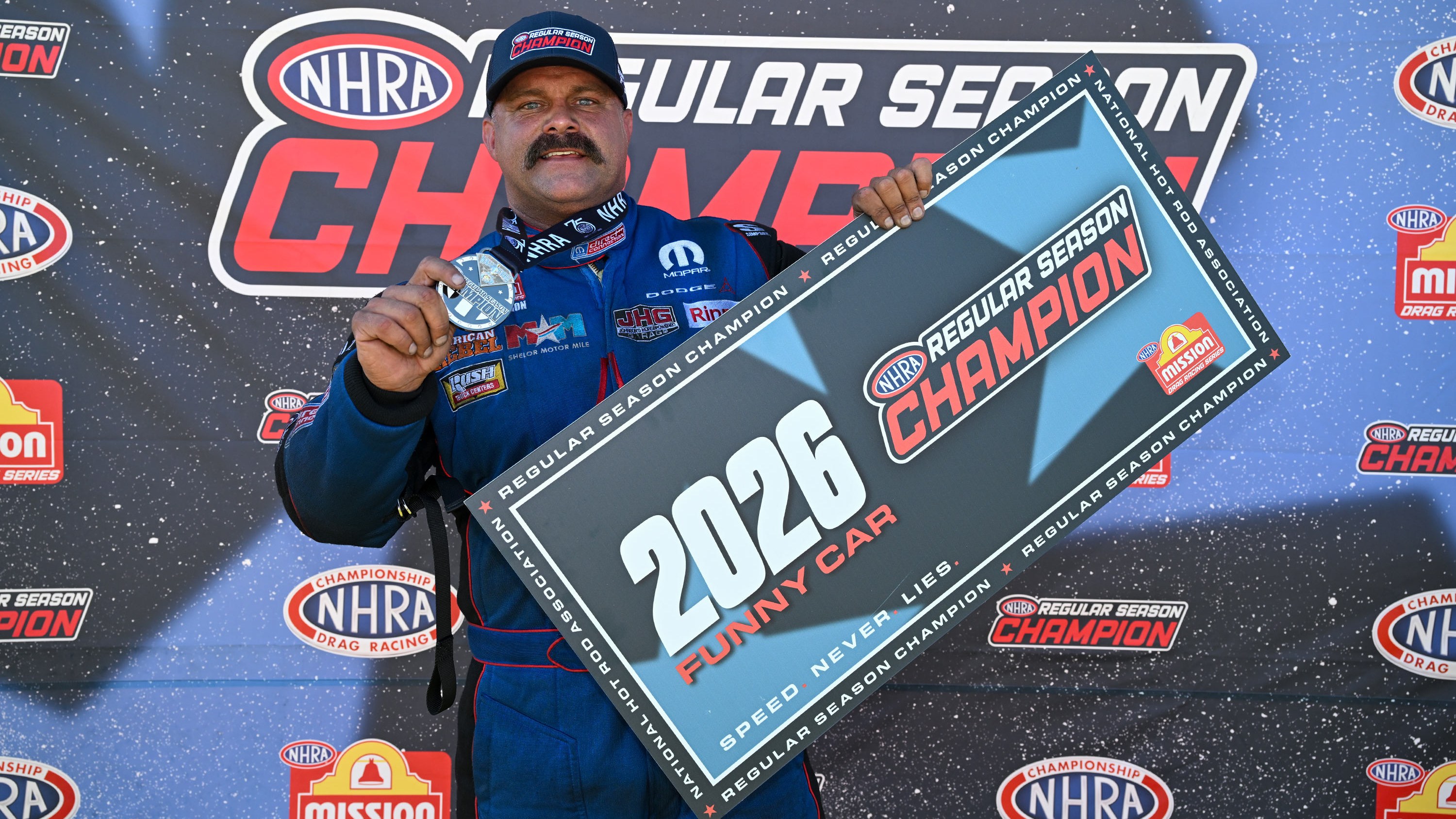 Matt Hagan holds 2026 NHRA Funny Car regular season champion banner