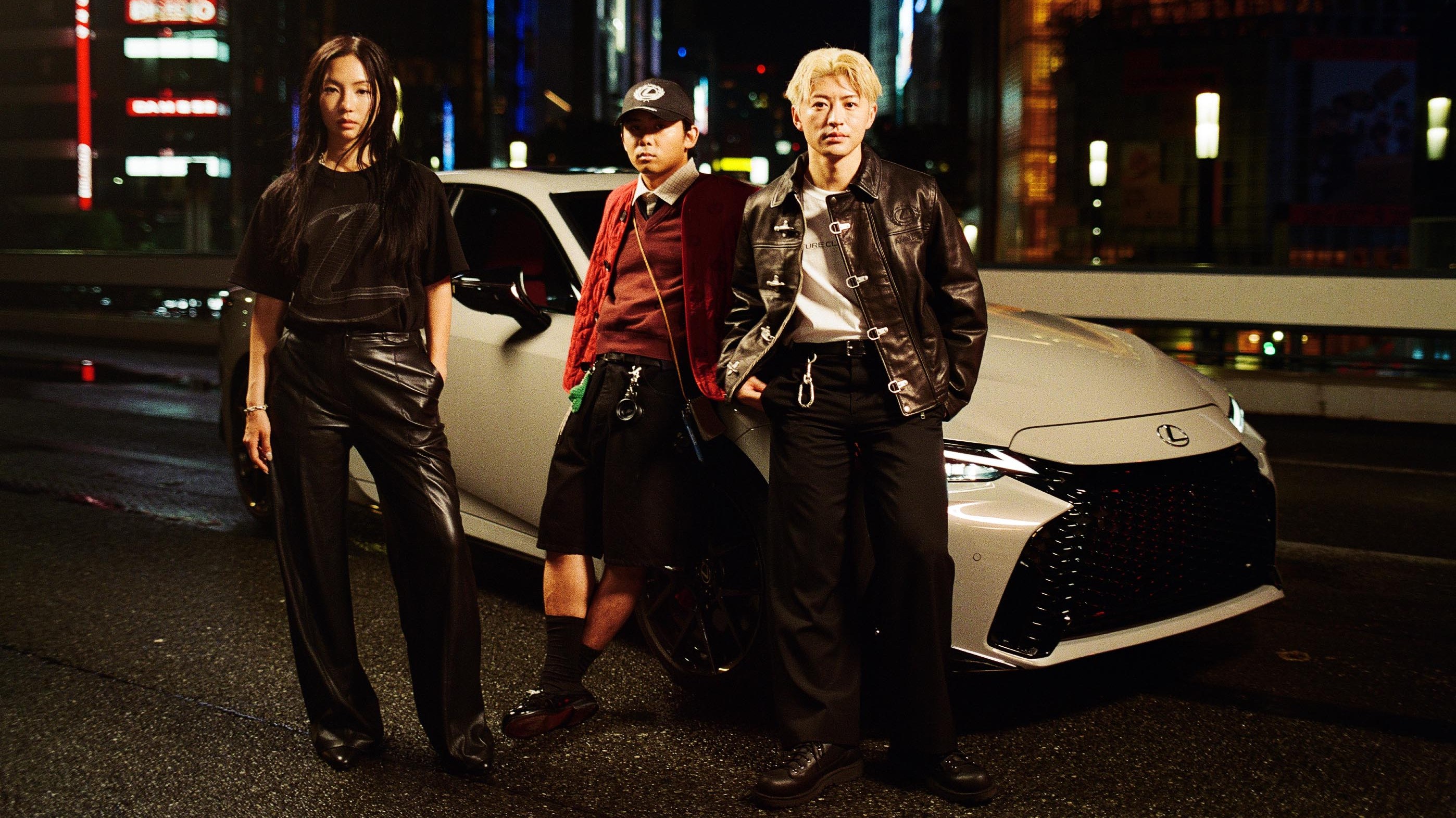 Sara Choi, Reiji Okamoto, and Reo Sano with a white Lexus IS in Tokyo
