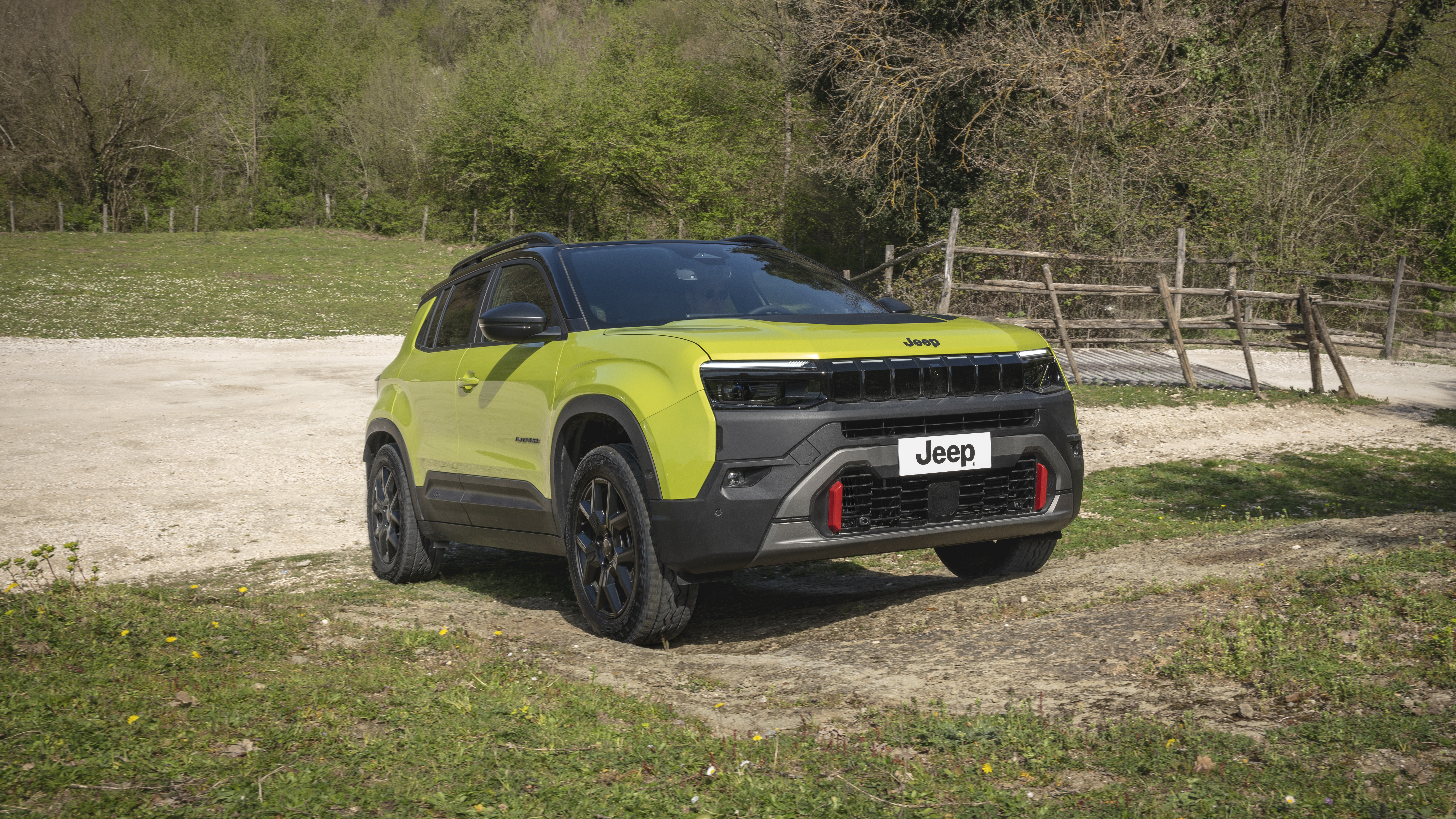 Refreshed Jeep Avenger 4xe front three-quarter view on a gravel trail