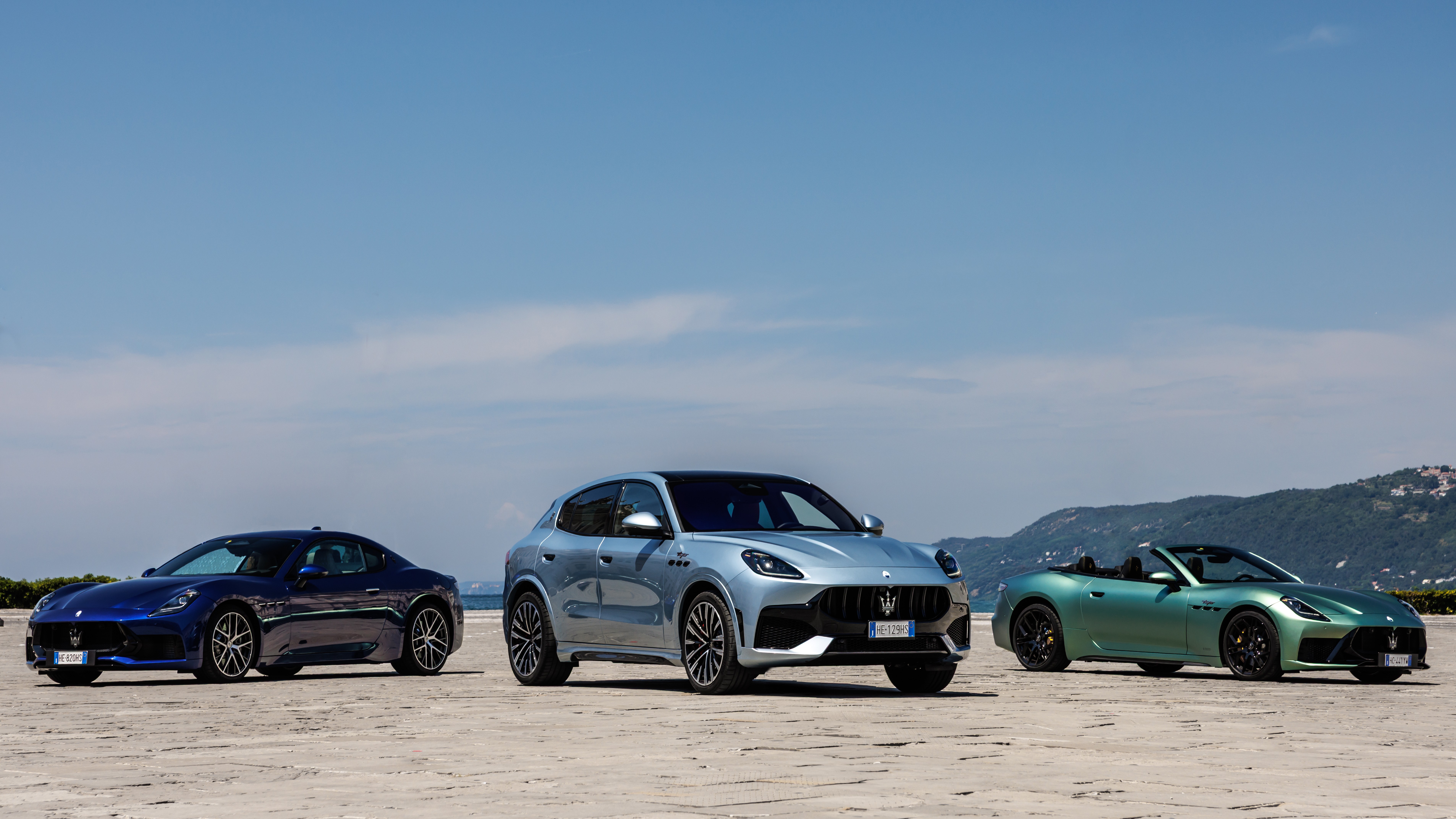 Maserati Grecale, GranTurismo, and GranCabrio parked together by the sea