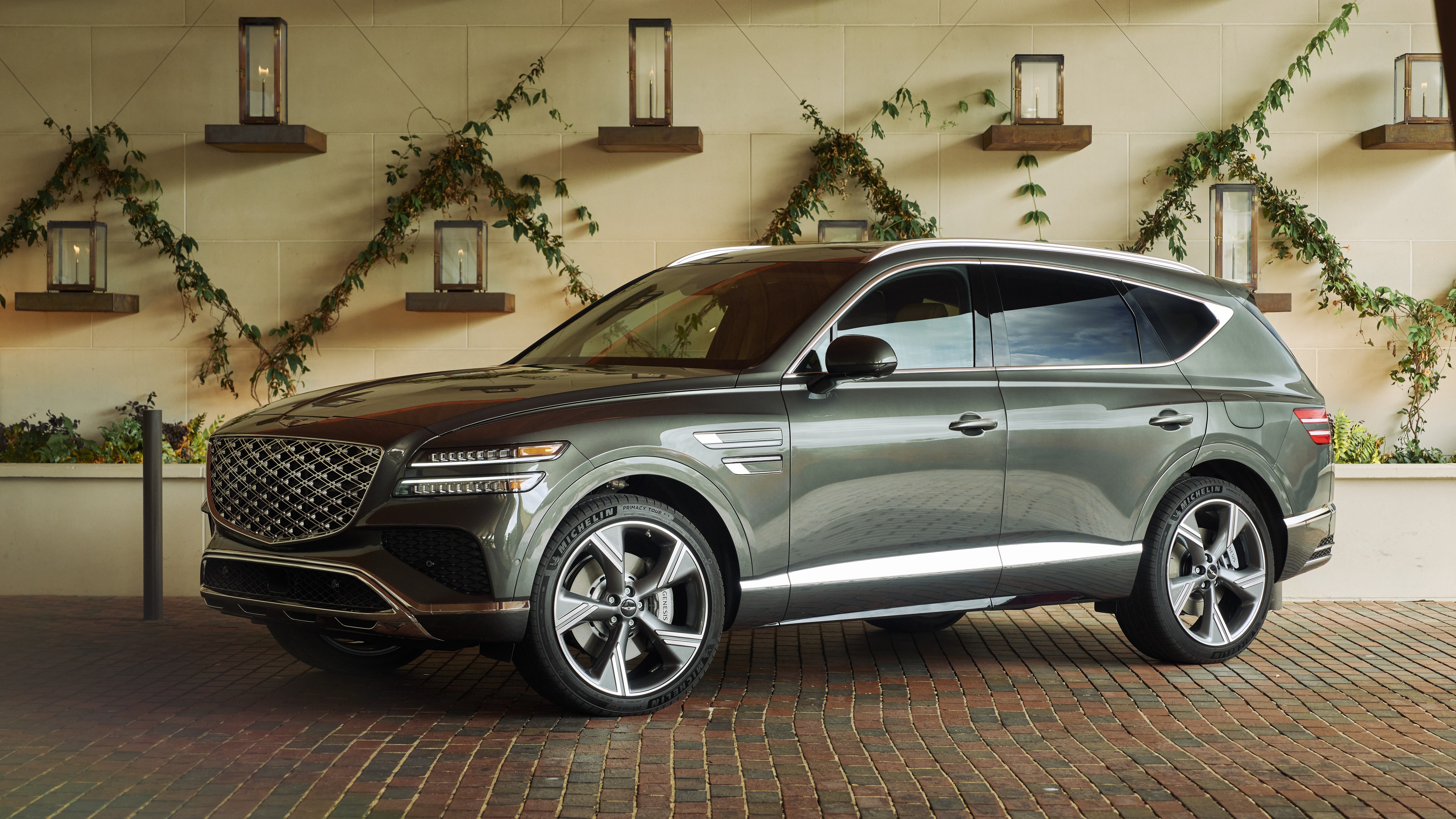 Genesis GV80 front three-quarter view parked outside a stone building