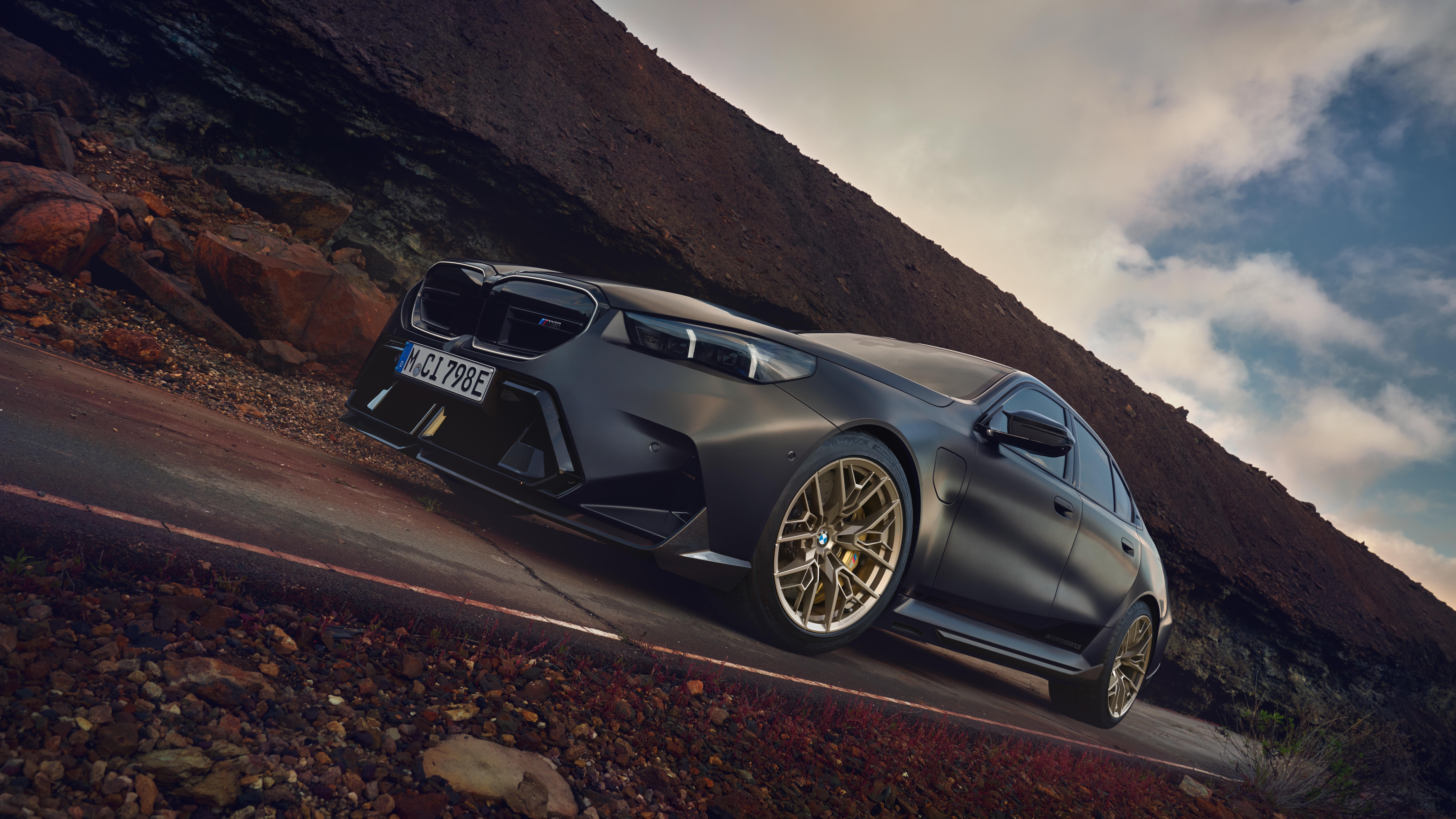 Matte gray BMW M5 sedan on Gold Bronze M Performance wheels
