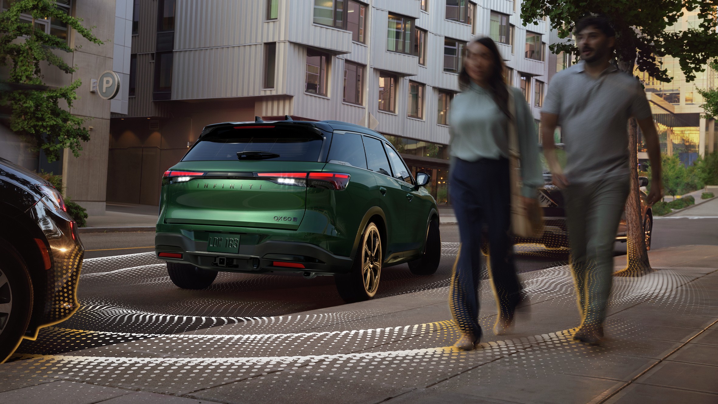 Green Infiniti QX60 on a city street with sensor graphics around it