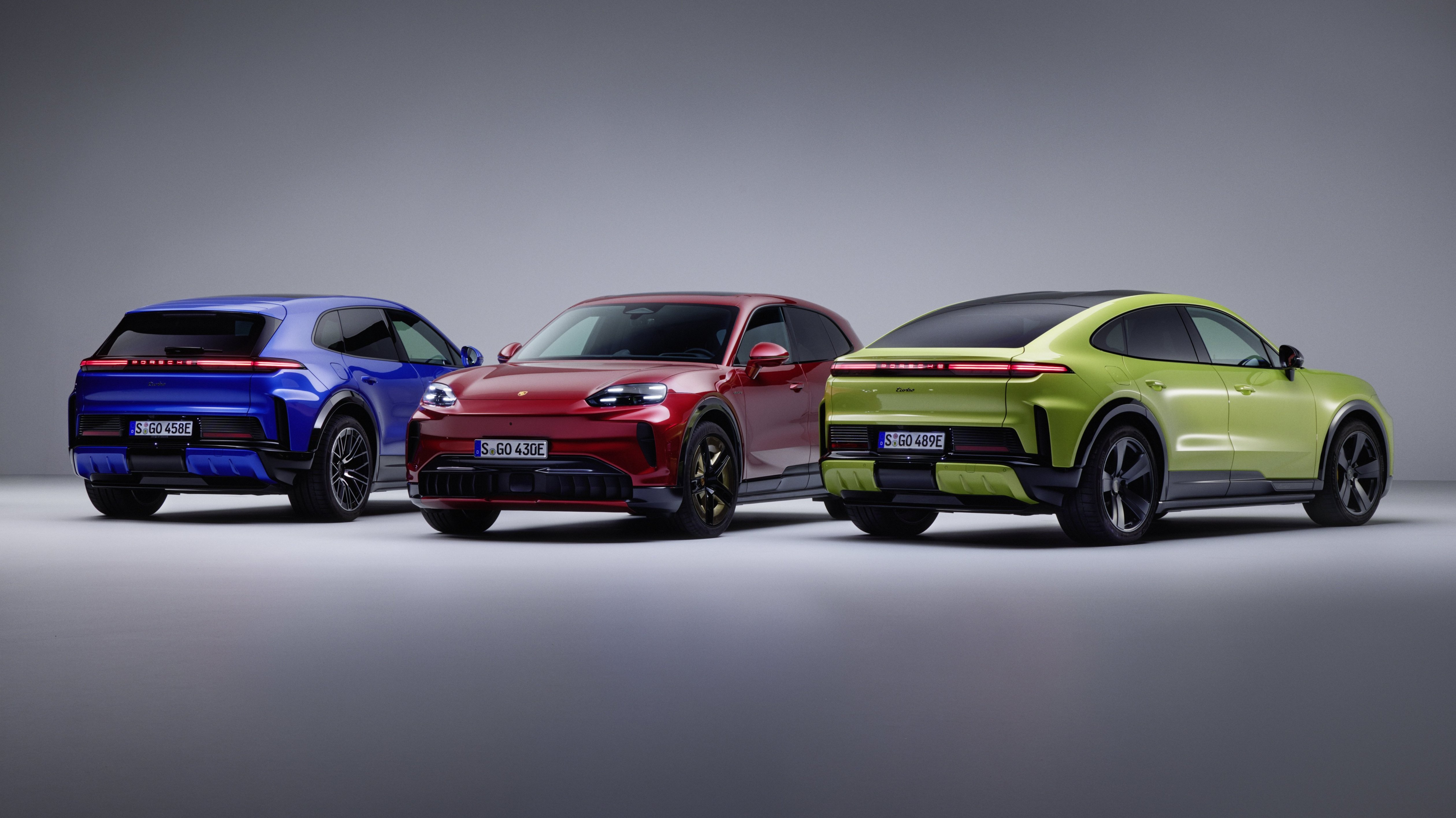 2027 Porsche Cayenne Electric lineup in blue, red, and green