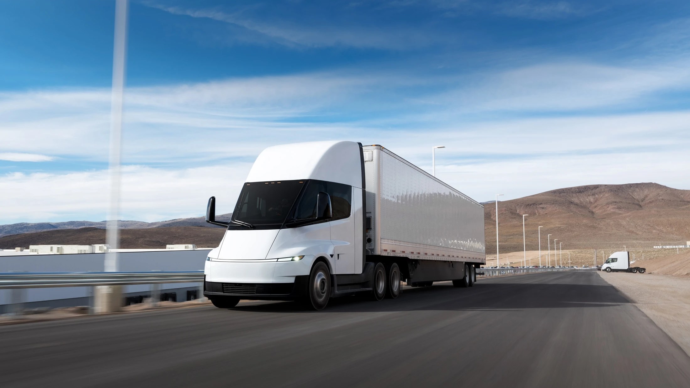 White Tesla Semi hauling a trailer on a desert highway near Gigafactory Nevada