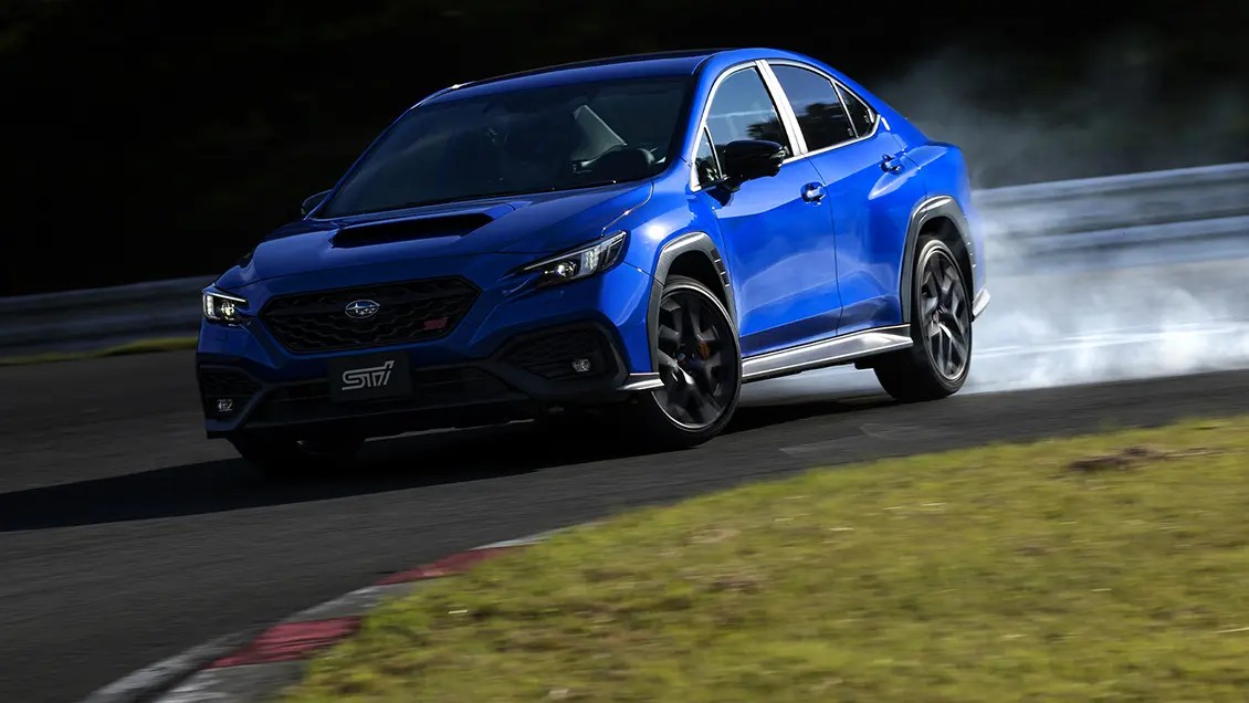Subaru WRX STI Sport cornering on track with tire smoke