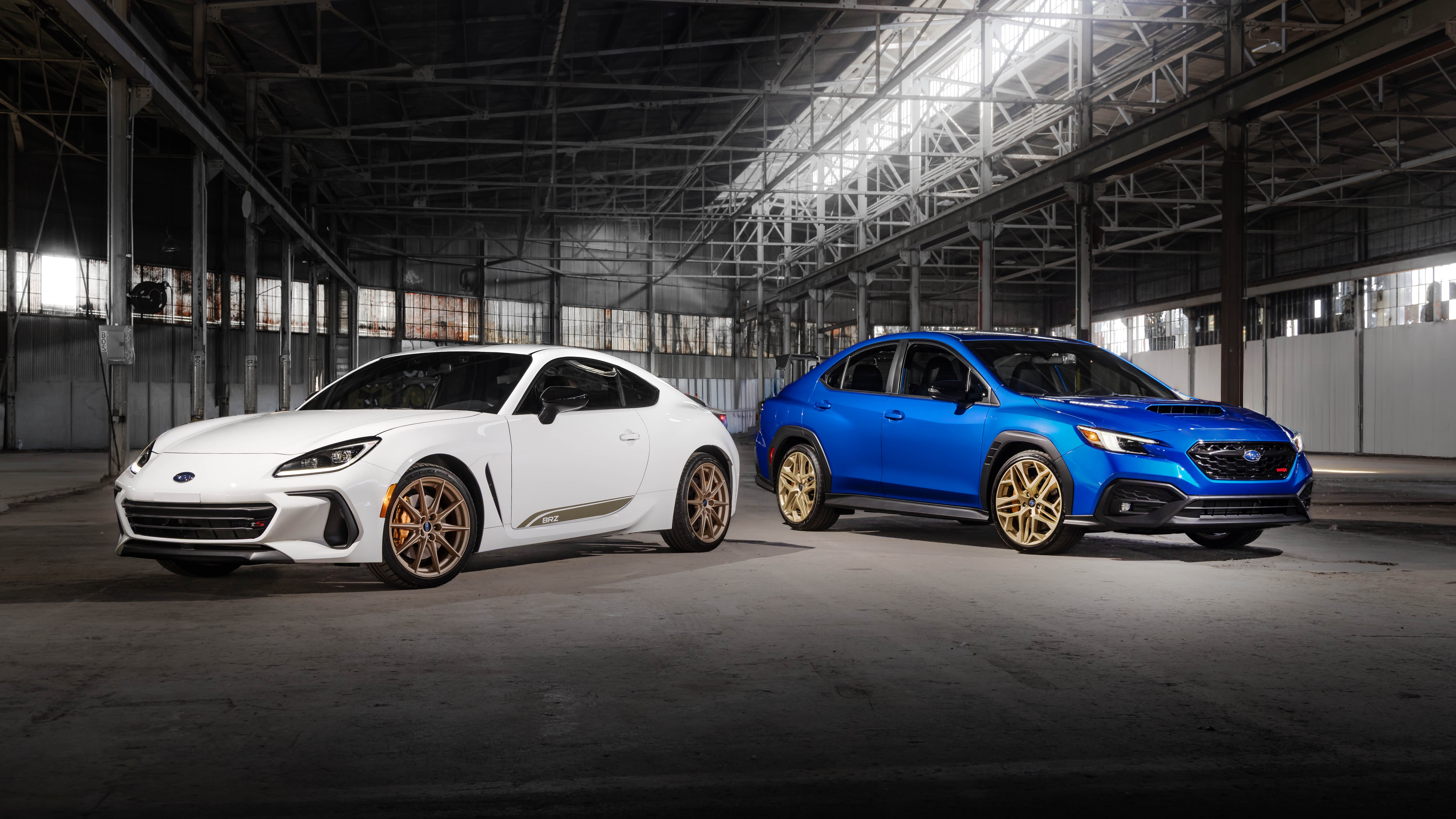 Subaru BRZ ZC15 in white and WRX GD25 in blue, front three-quarter view