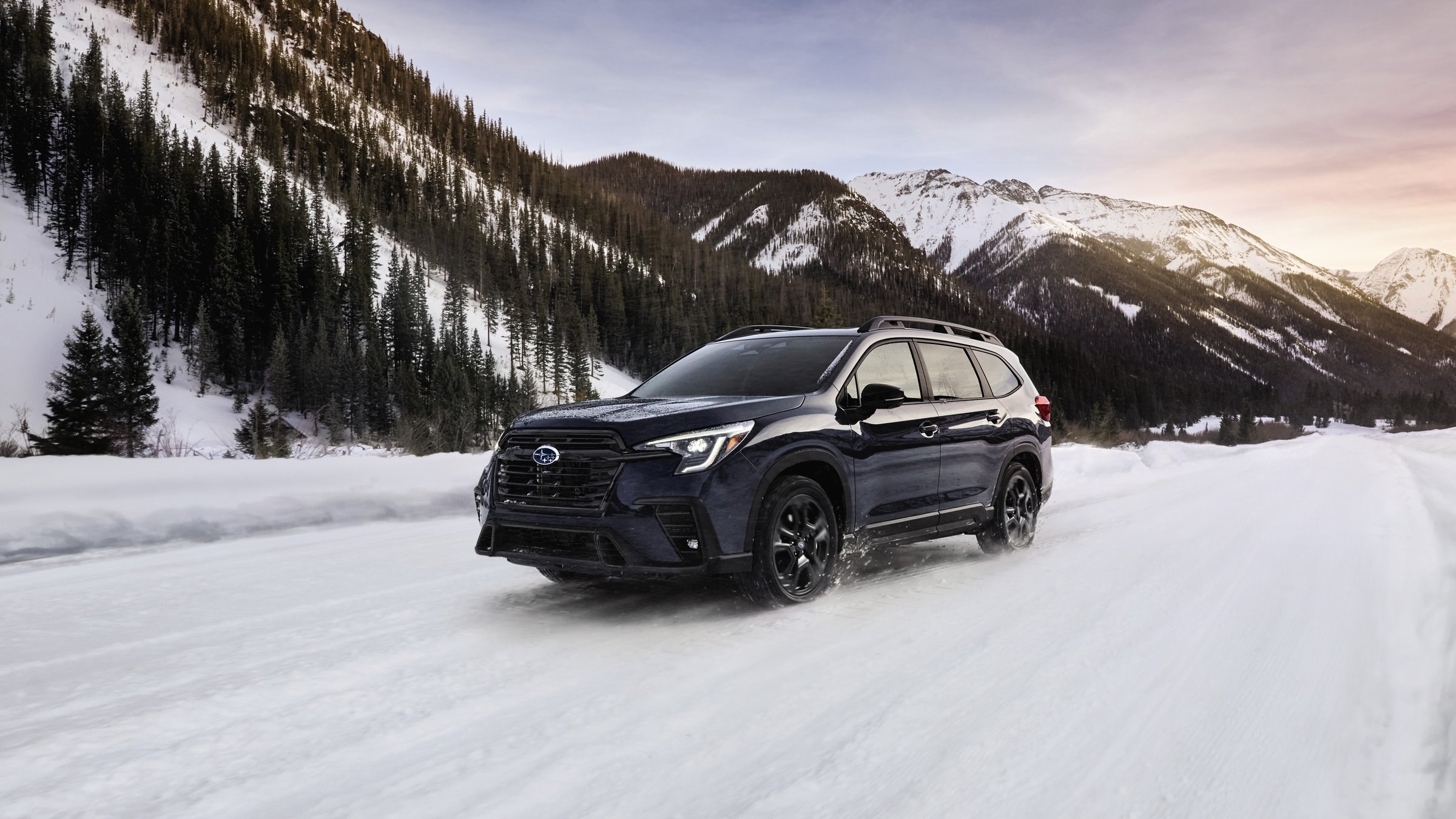 Subaru Ascent SUV driving on a snow-covered mountain road