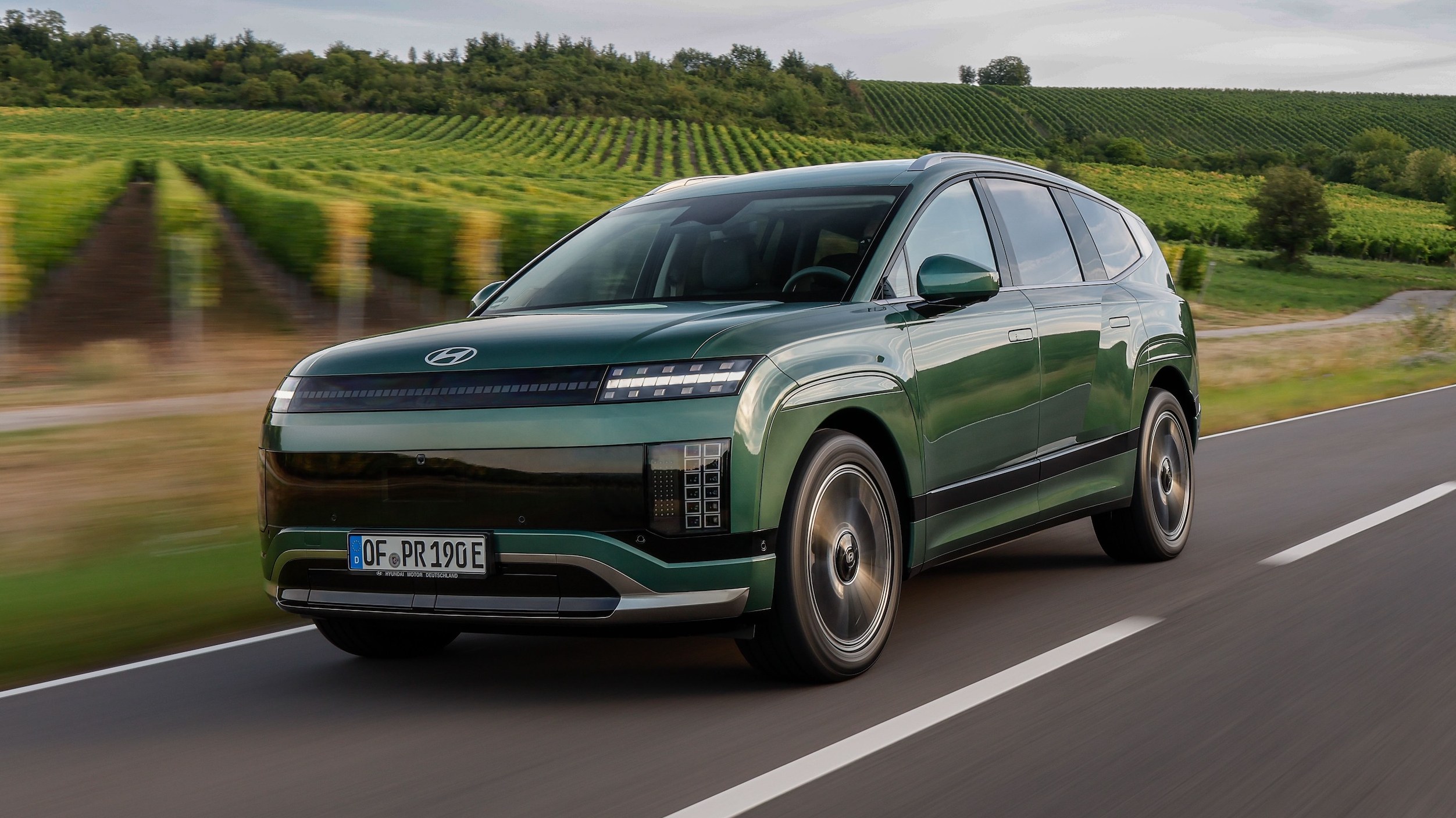 2026 Hyundai Ioniq 9 electric SUV driving on a country road, front three-quarter view