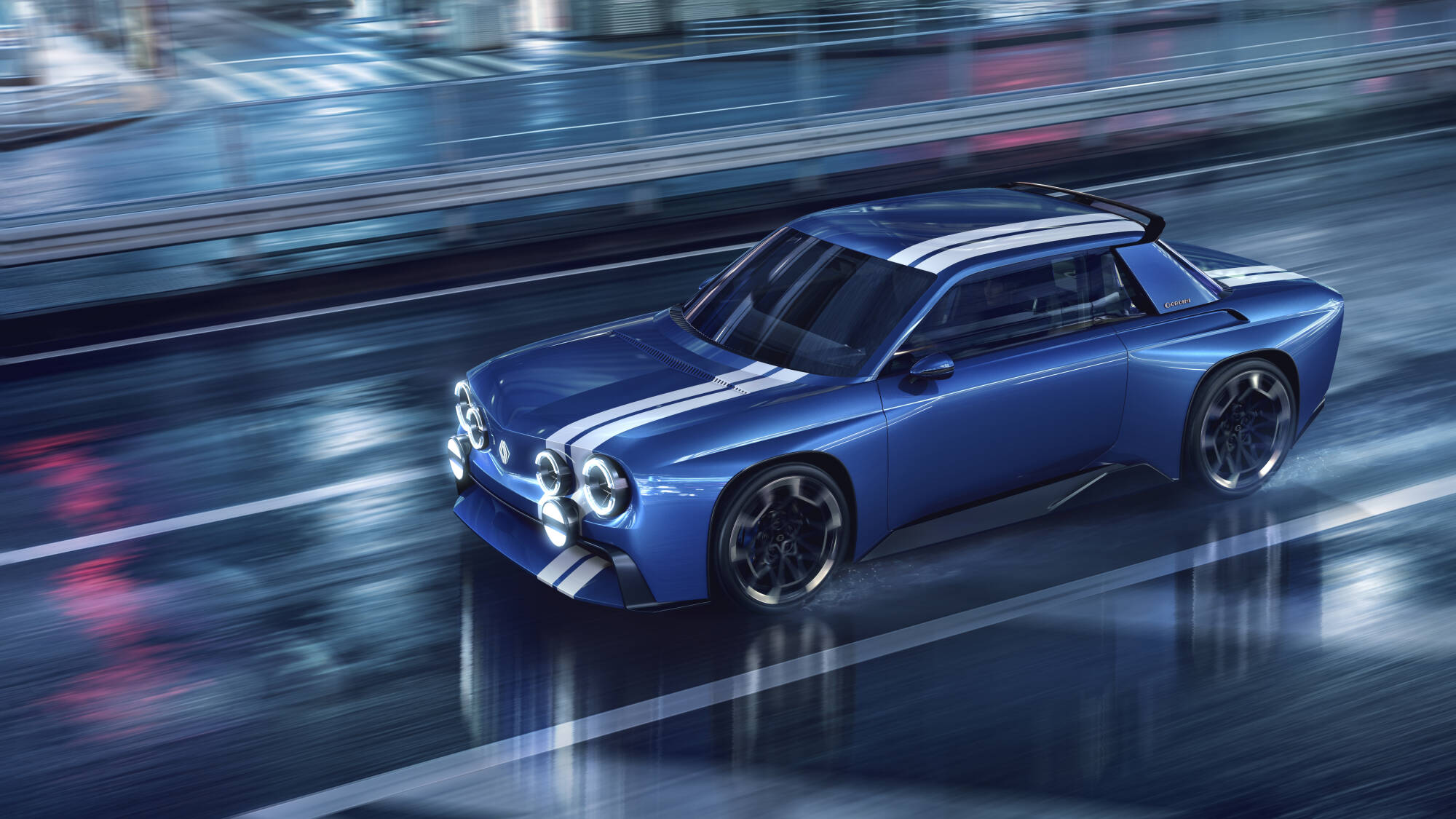 Blue Renault 8 Gordini Concept electric coupe driving on a wet city street