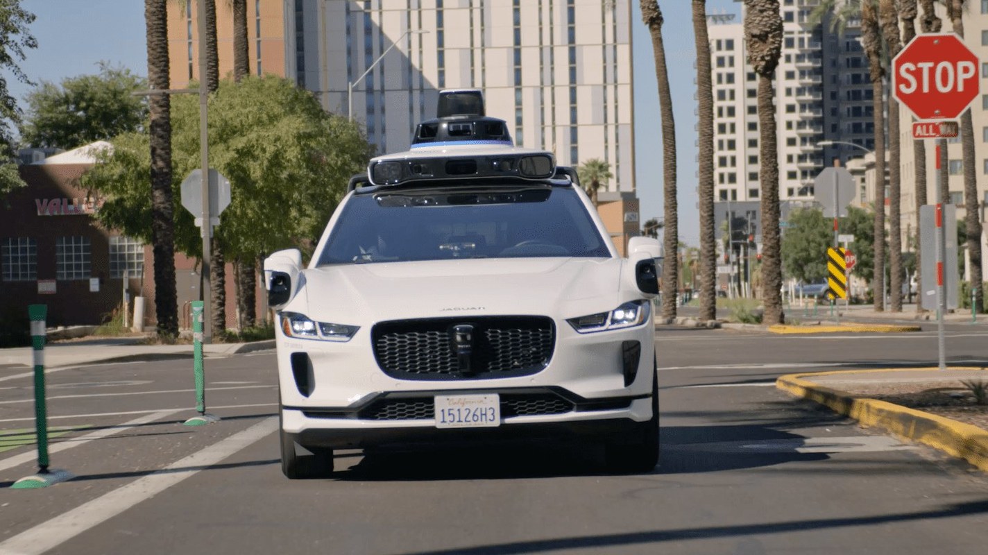 Waymo Jaguar I-Pace robotaxi driving through downtown Phoenix