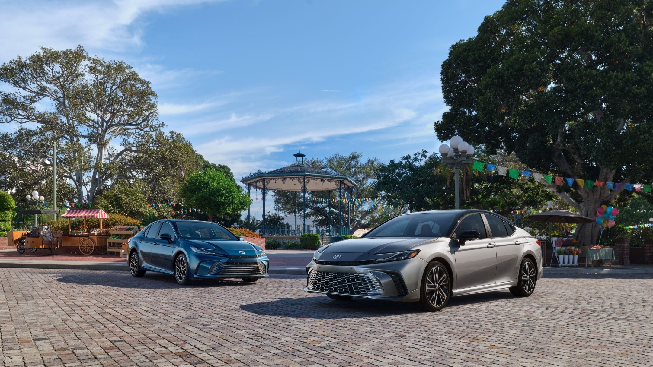 2027 Toyota Camry XLE and XSE parked side by side in a town square