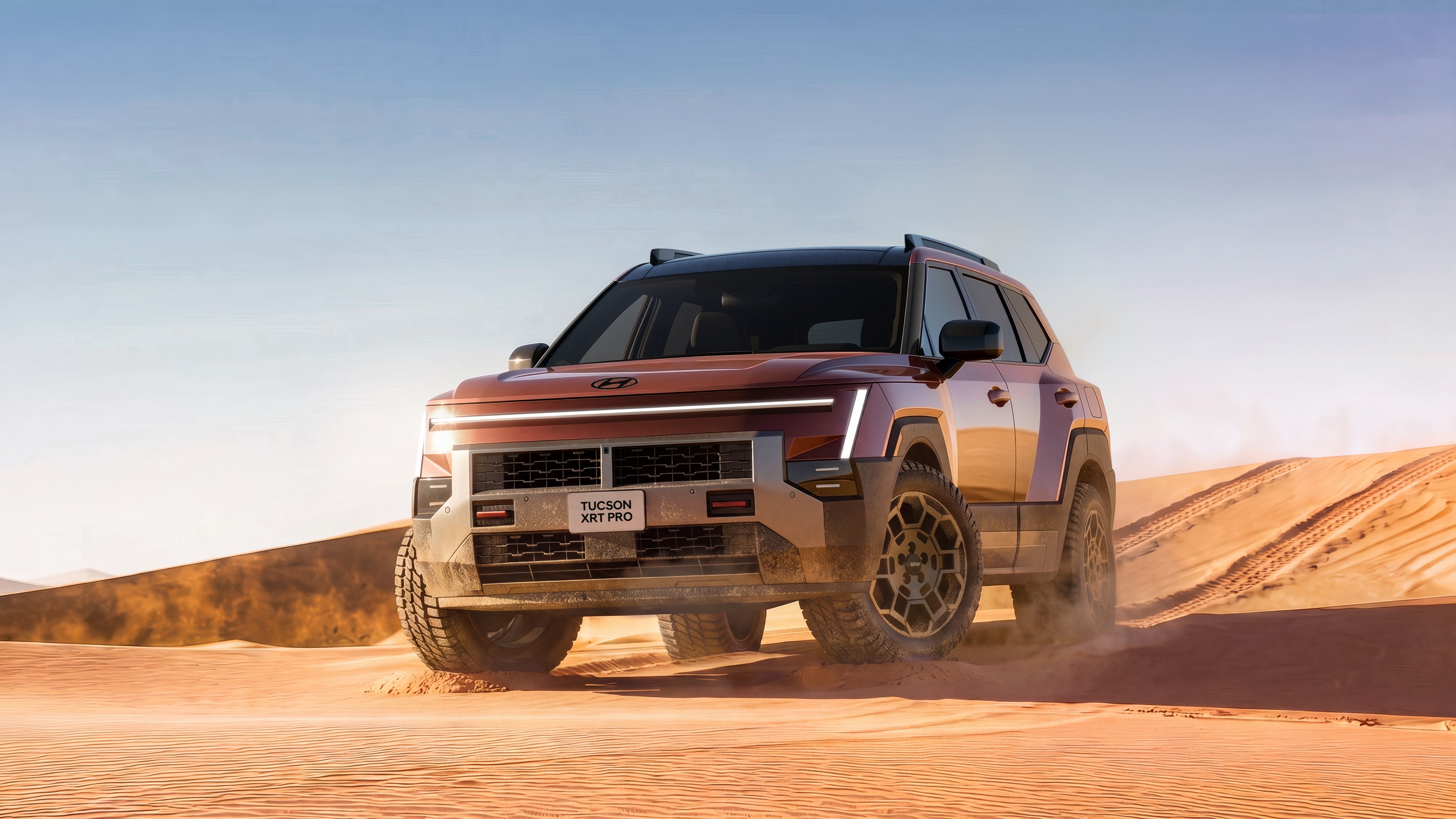 2027 Hyundai Tucson XRT PRO driving on desert sand dunes
