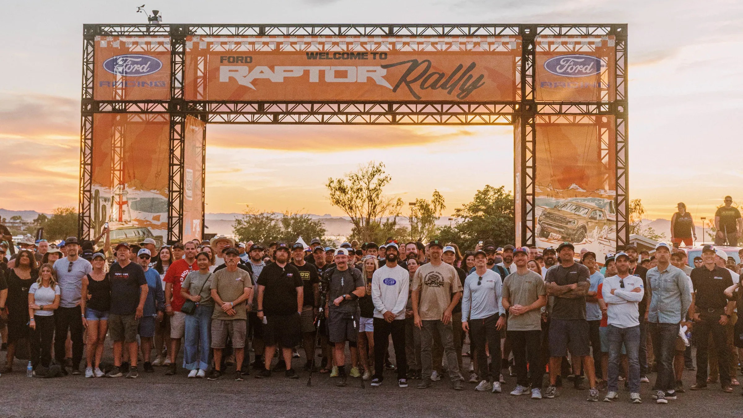 Raptor Rally 2026 attendees gathered under the welcome arch at sunset in Lake Havasu