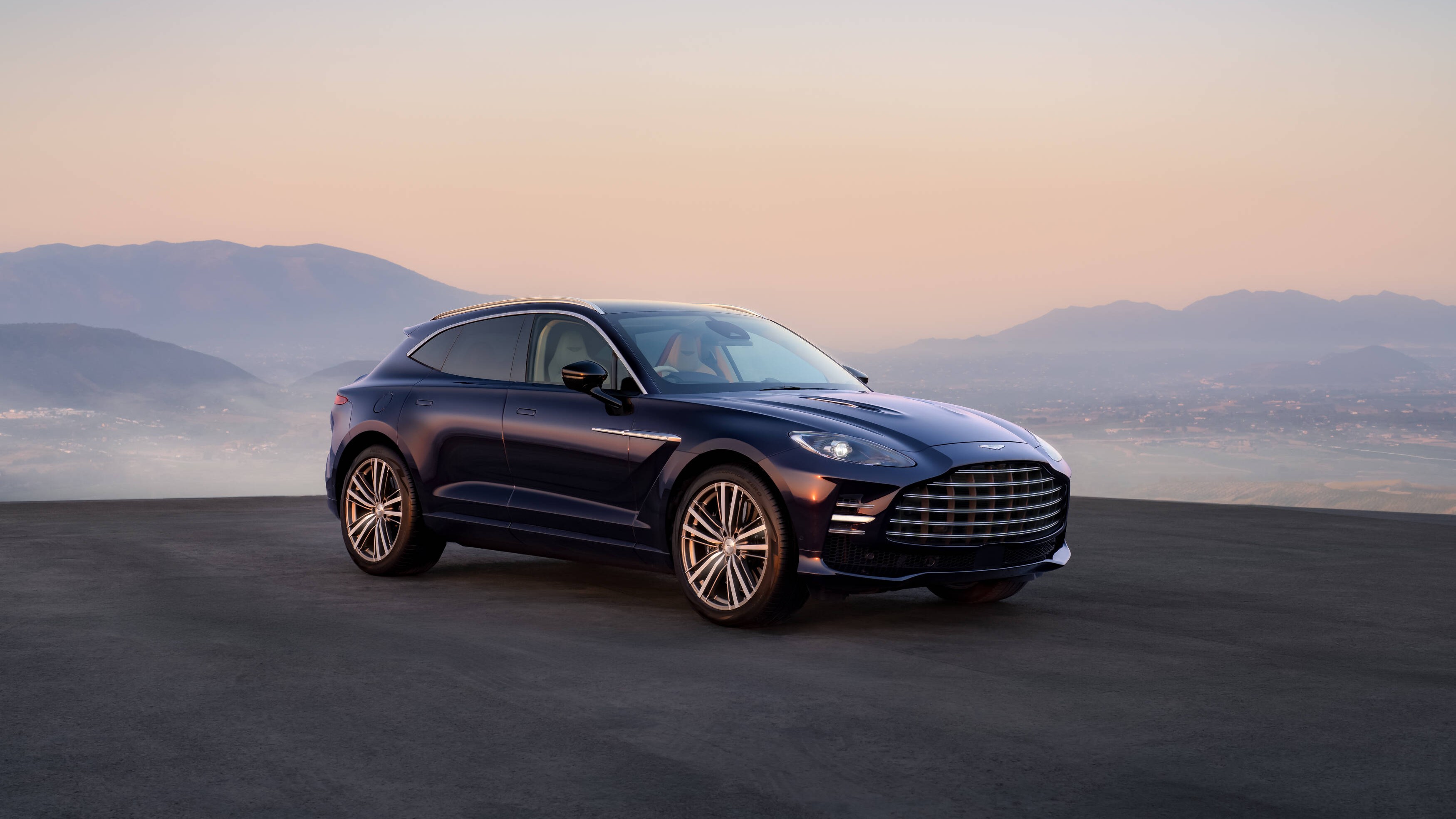 Aston Martin DBX GT front three-quarter view at dawn