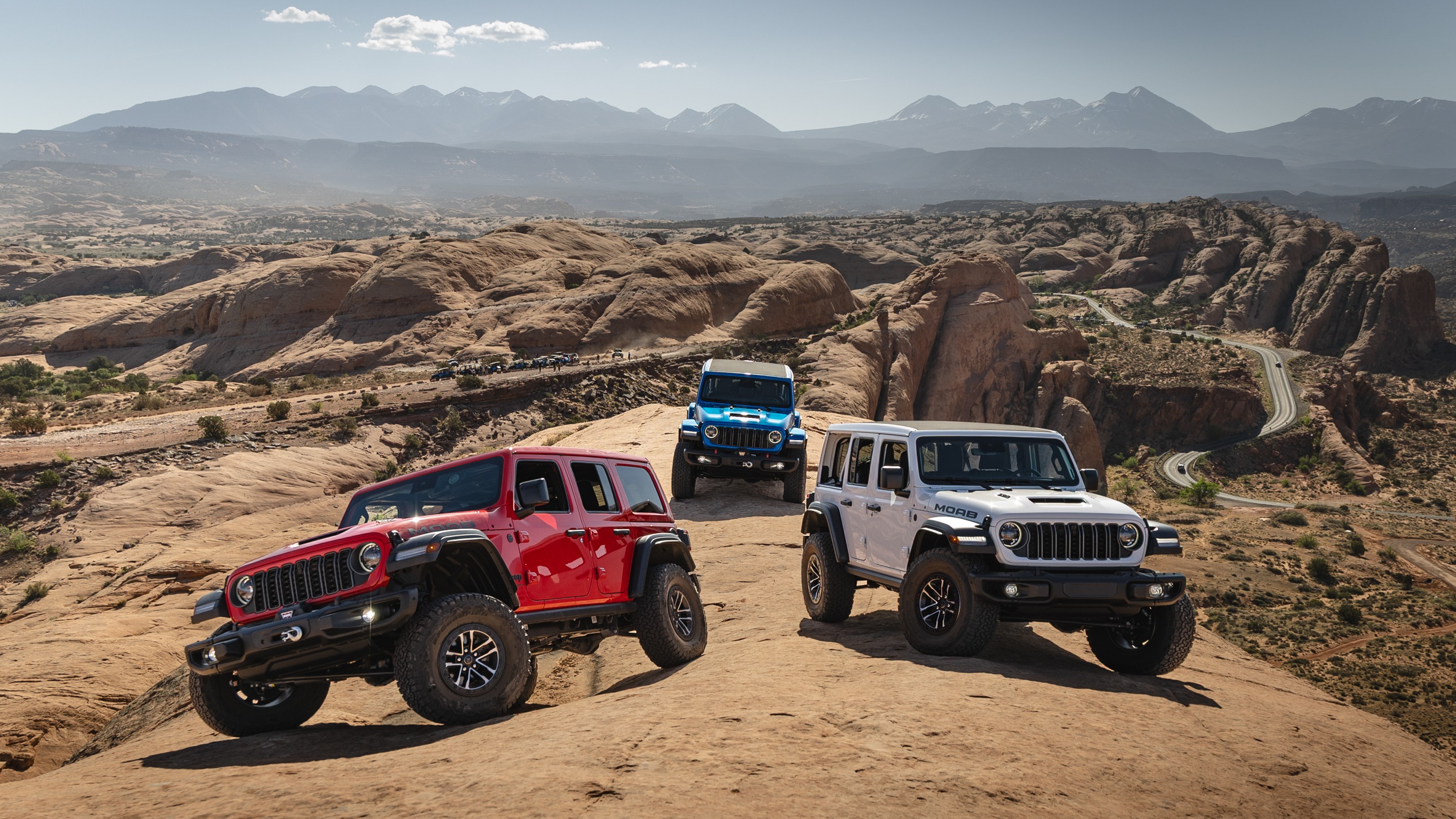 Three Jeep Wrangler Unlimited SUVs on slickrock near Moab, Utah