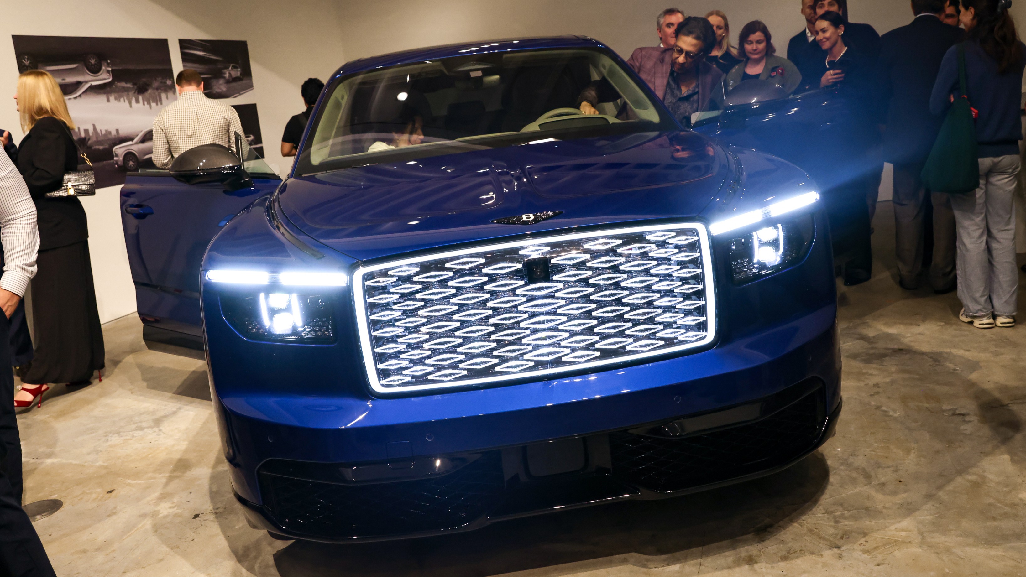 Blue Bentley Torcal S with illuminated grille inside a New York gallery
