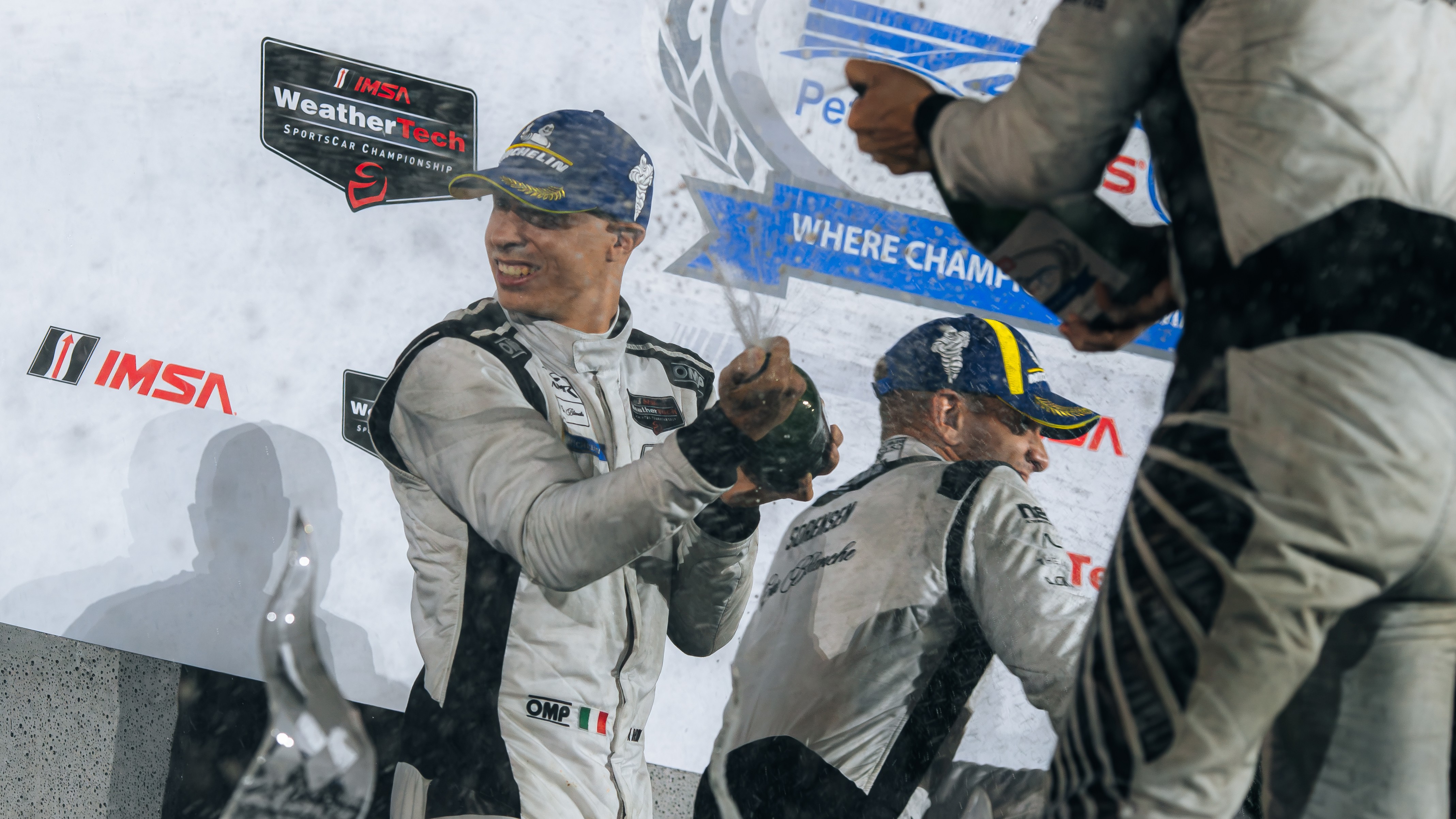 Car Blanche drivers spray champagne on the Petit Le Mans podium