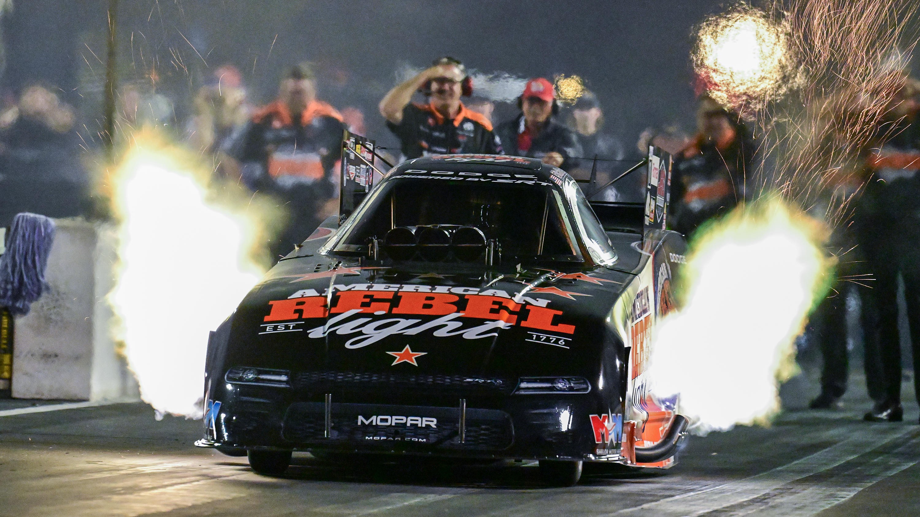 Matt Hagan's Dodge//SRT Hellcat Funny Car launching at night with header flames