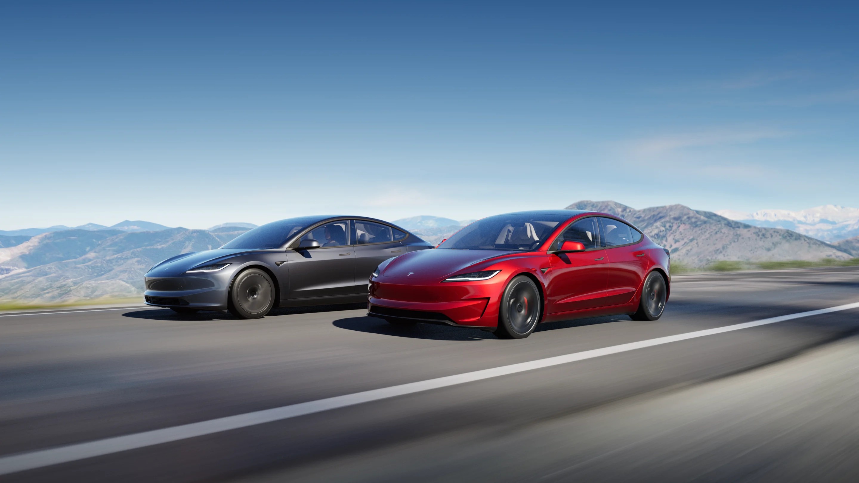 Red Tesla Model 3 sedan, front three-quarter view
