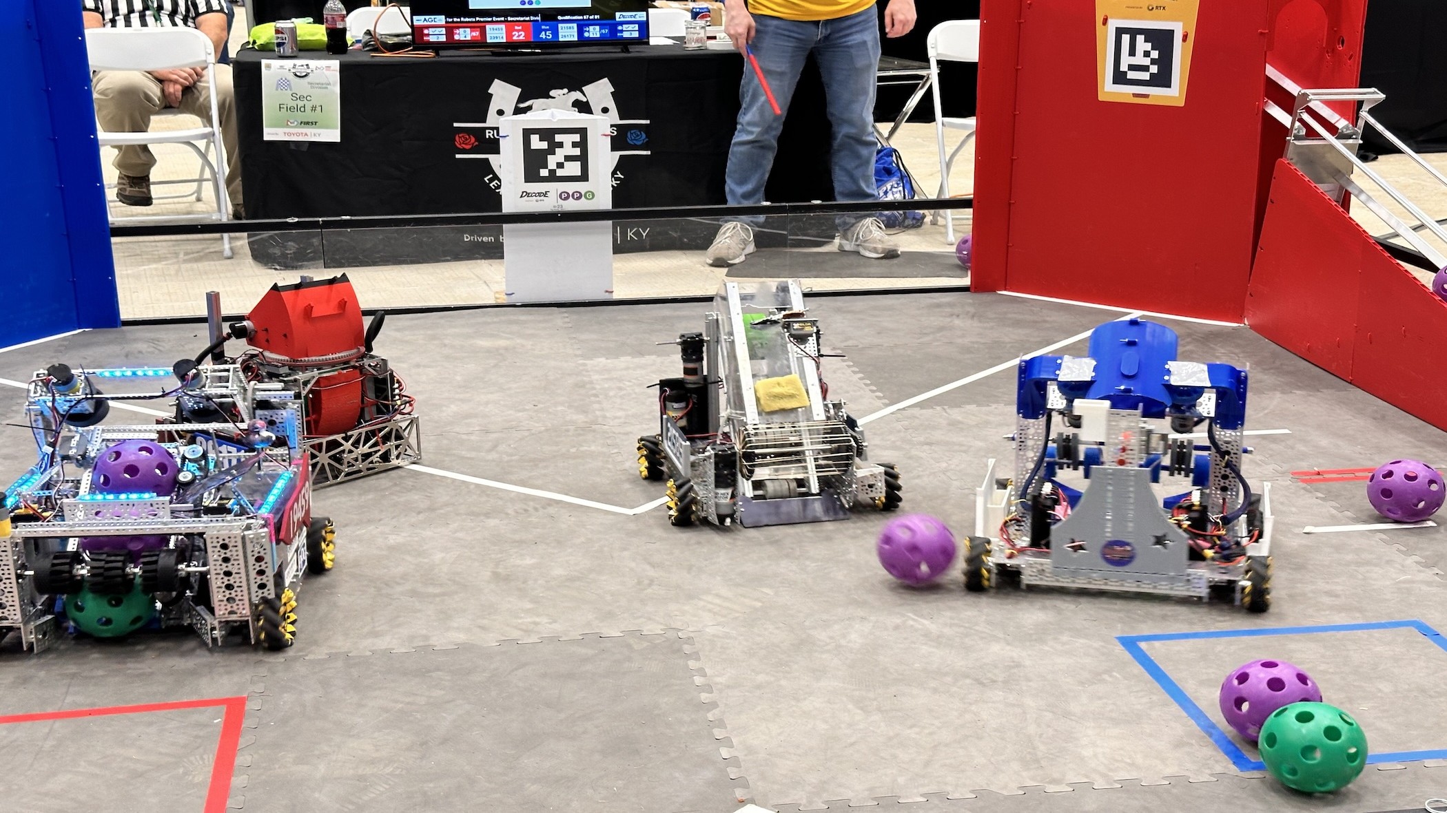 Student-built robots on a FIRST Tech Challenge field during a match