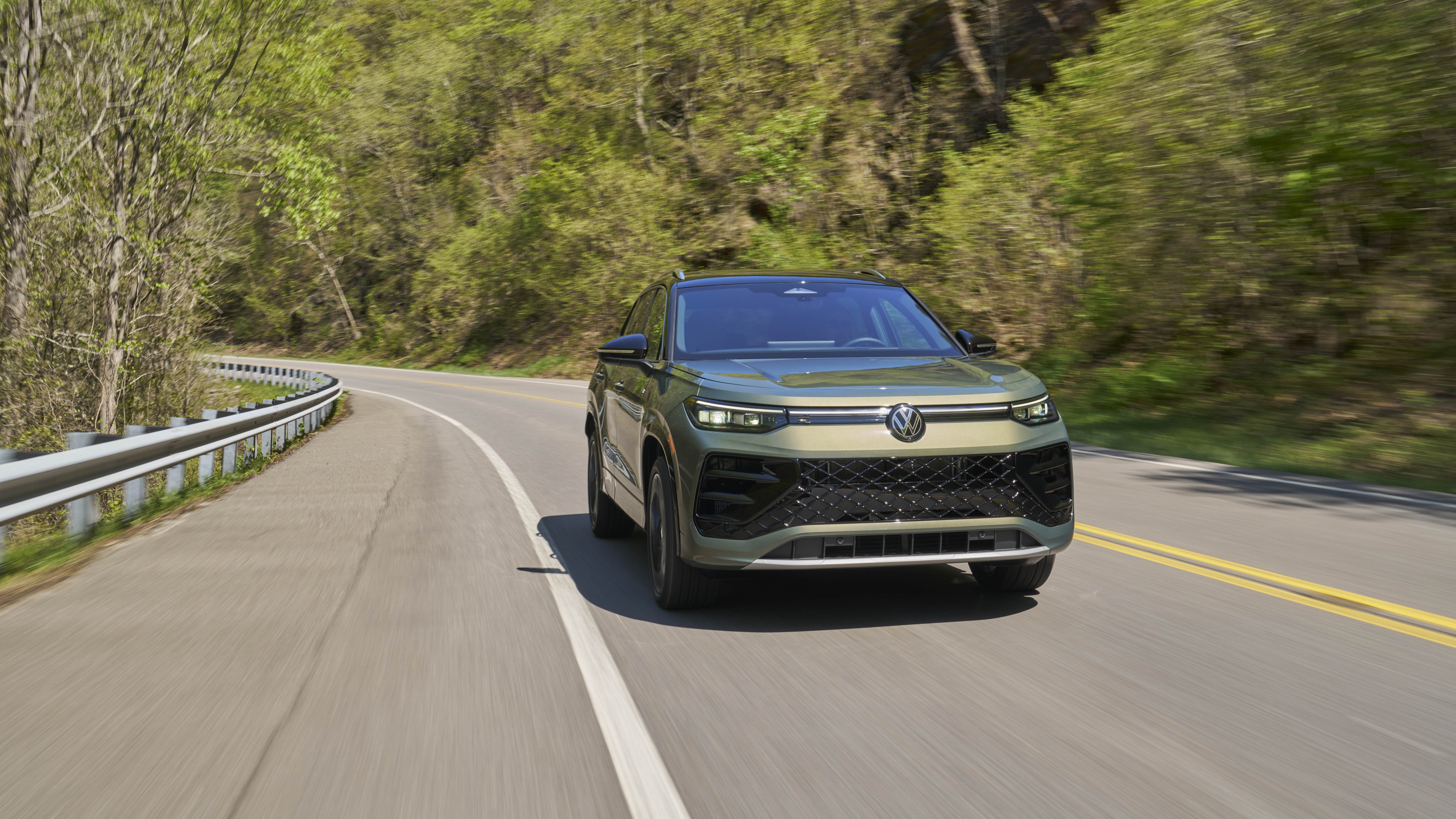 2026 Volkswagen Tiguan SEL R-Line Turbo in green driving on a mountain road