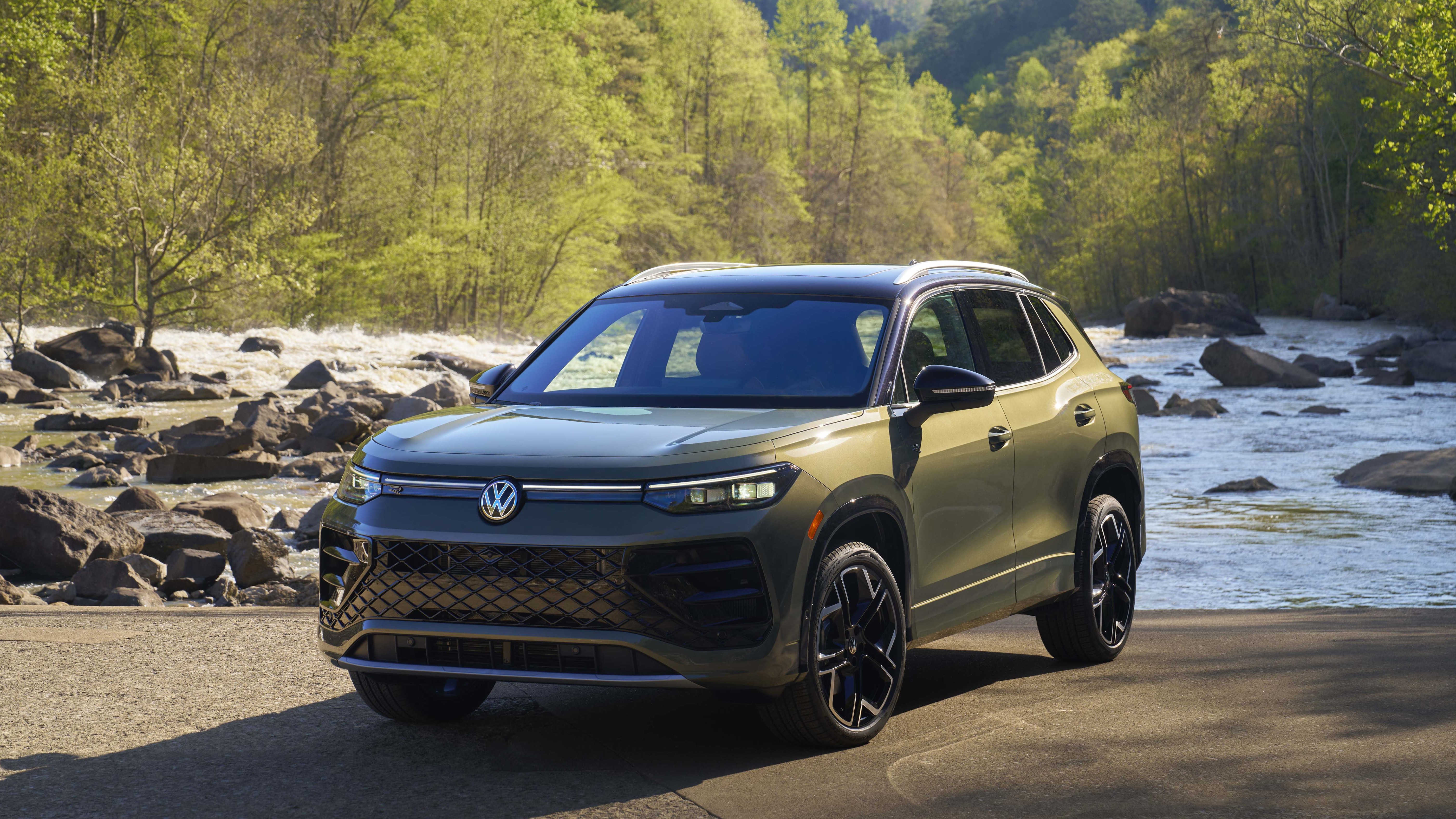 2026 Volkswagen Tiguan front three-quarter view, parked by a river