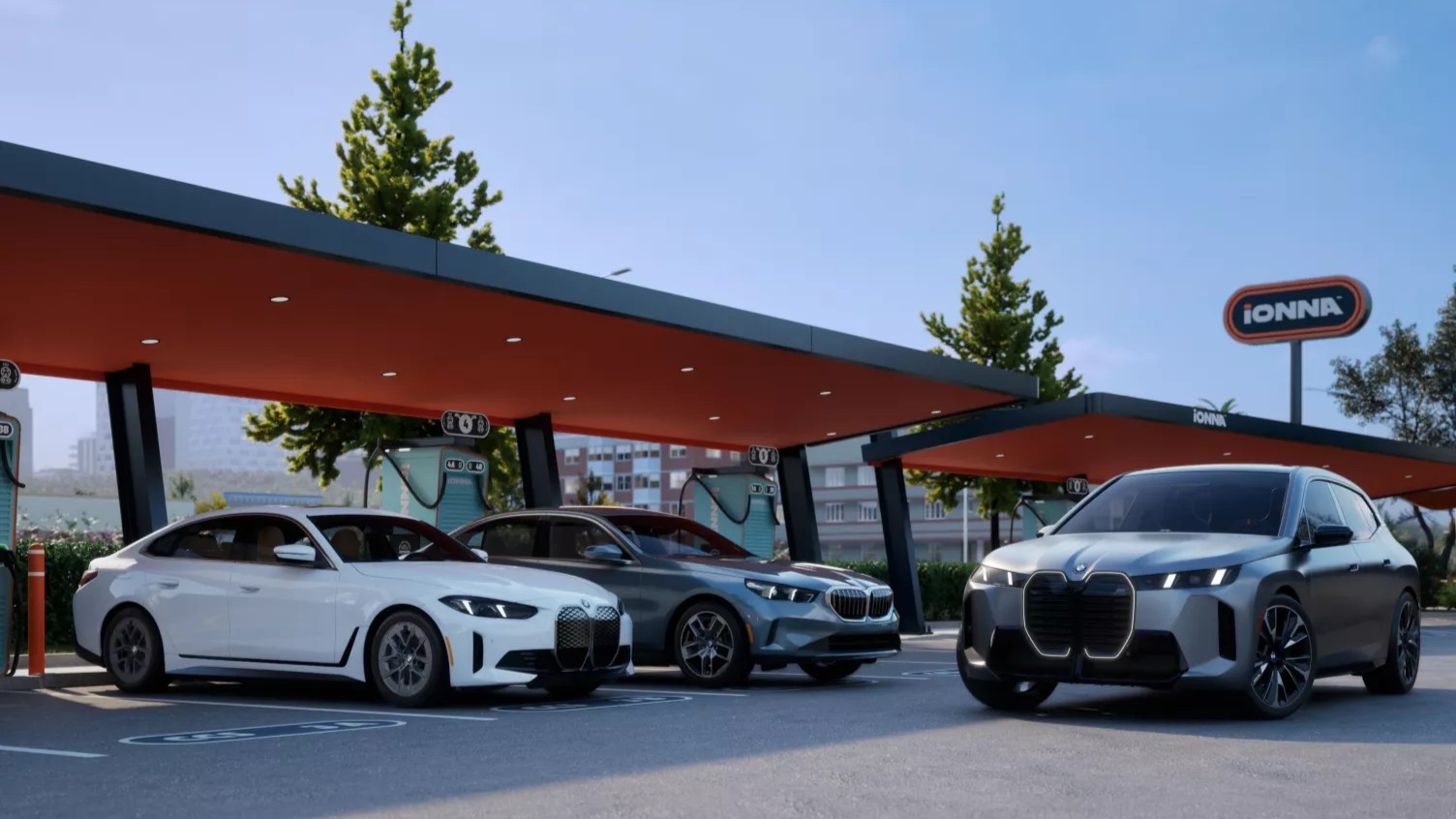 BMW i4, i5 and iX electric cars at an IONNA fast-charging station