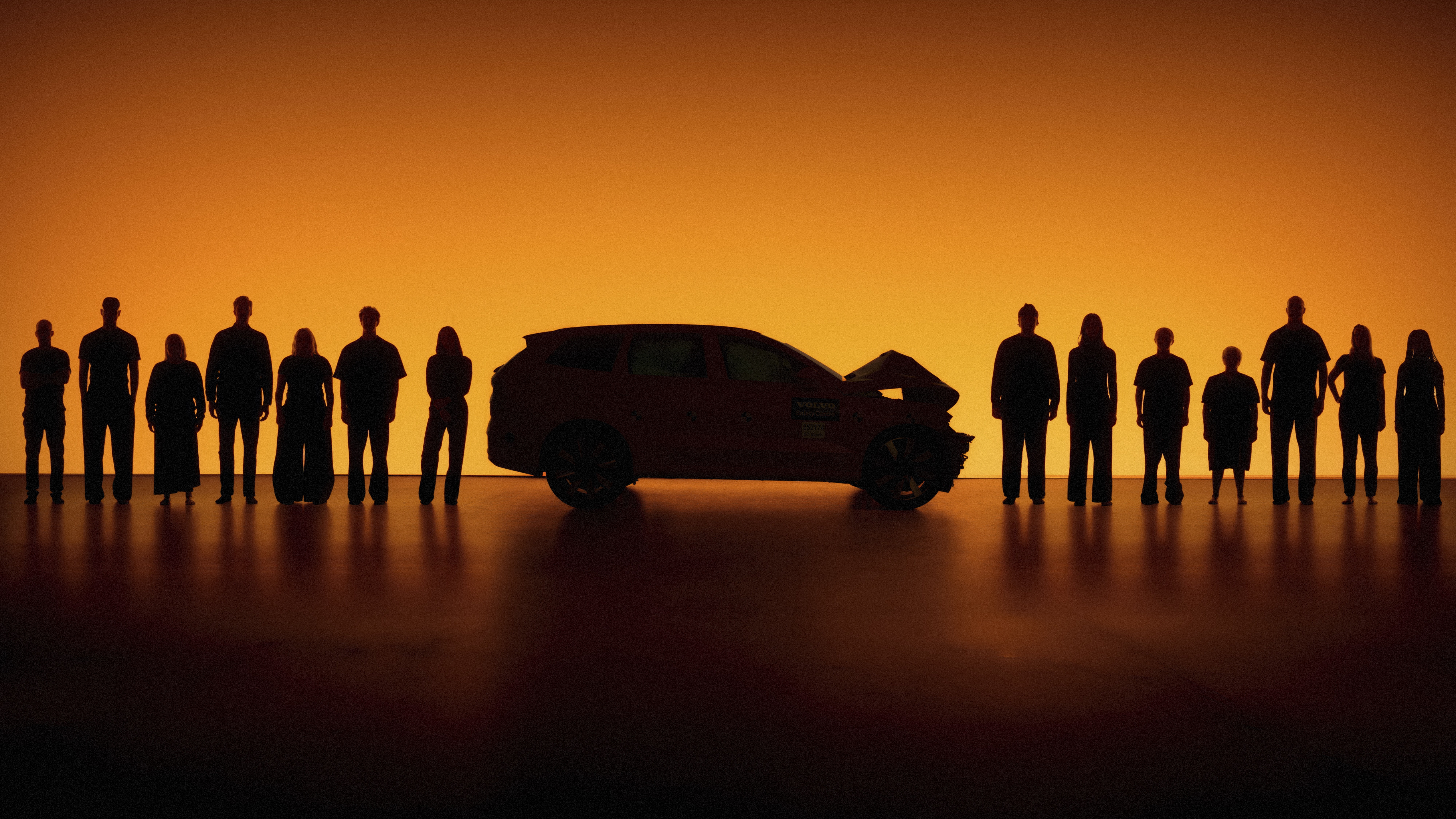 Silhouettes of people of different sizes beside a crash-tested Volvo SUV