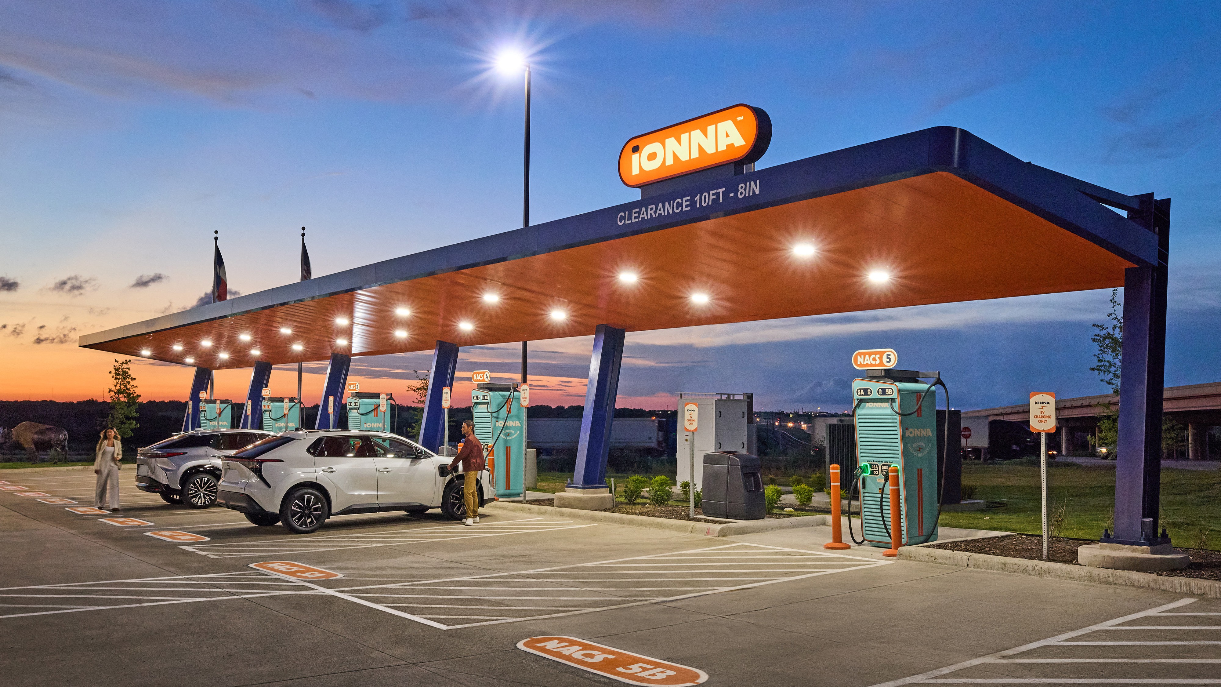 Toyota bZ and Lexus RZ charging at an IONNA Rechargery at dusk