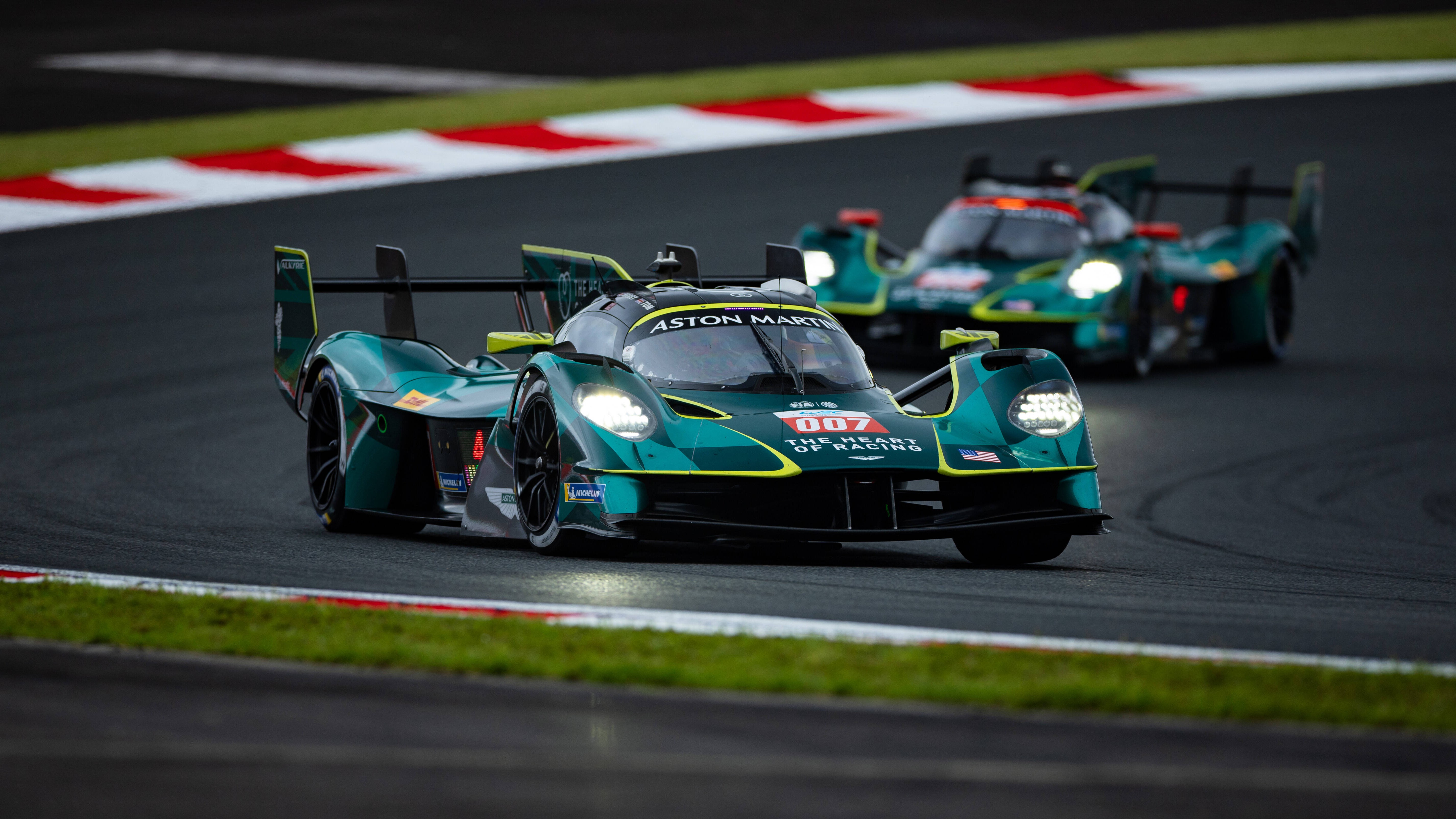 Two Aston Martin Valkyrie Hypercars cornering nose-to-tail during the WEC 6 Hours of Fuji