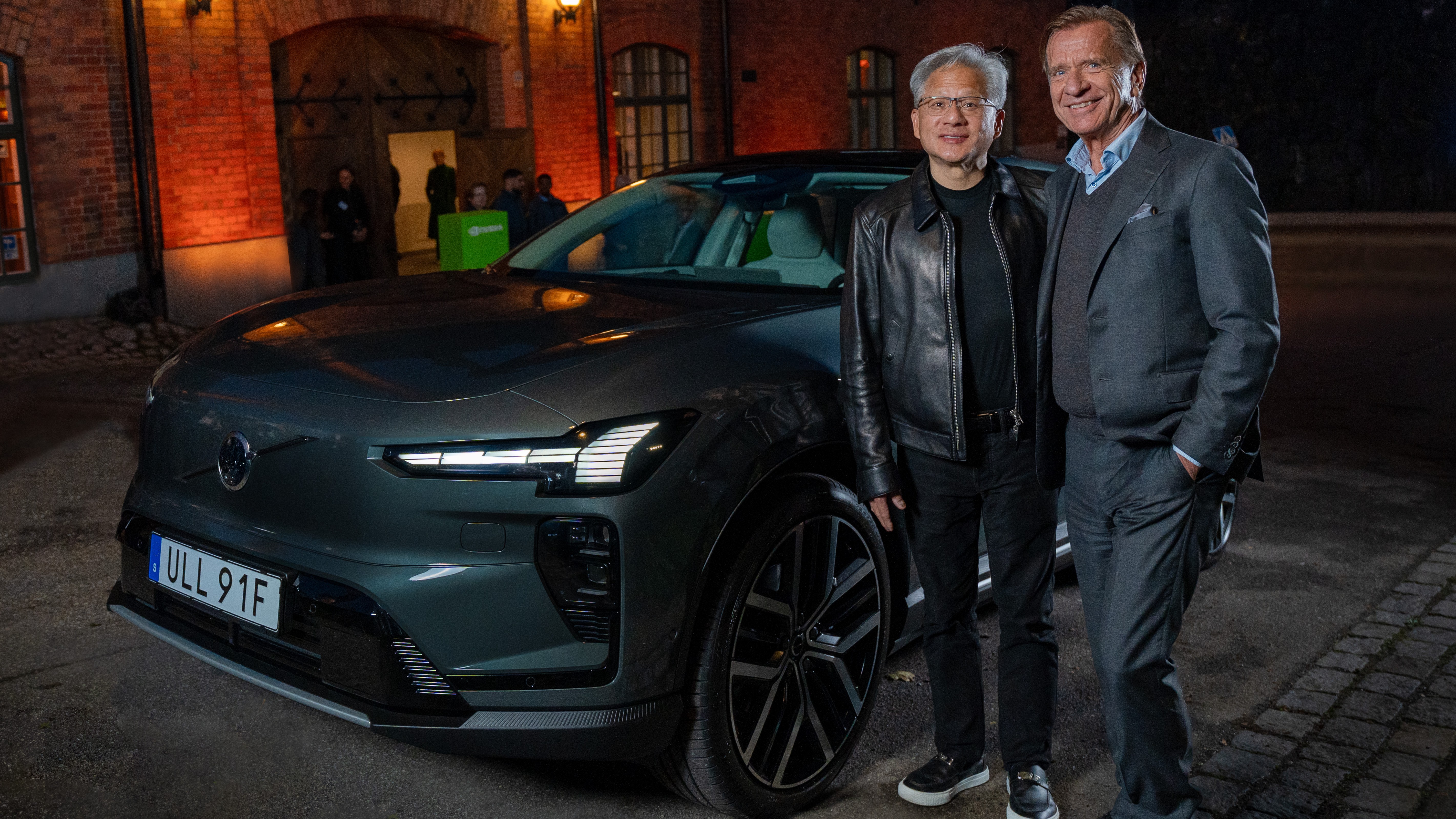 NVIDIA CEO Jensen Huang and Volvo CEO Håkan Samuelsson beside a Volvo EX60