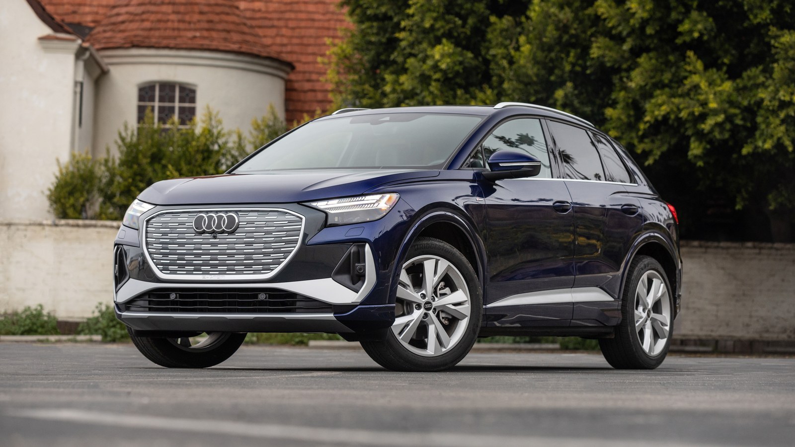 Dark blue Audi Q4 e-tron parked in front of a house