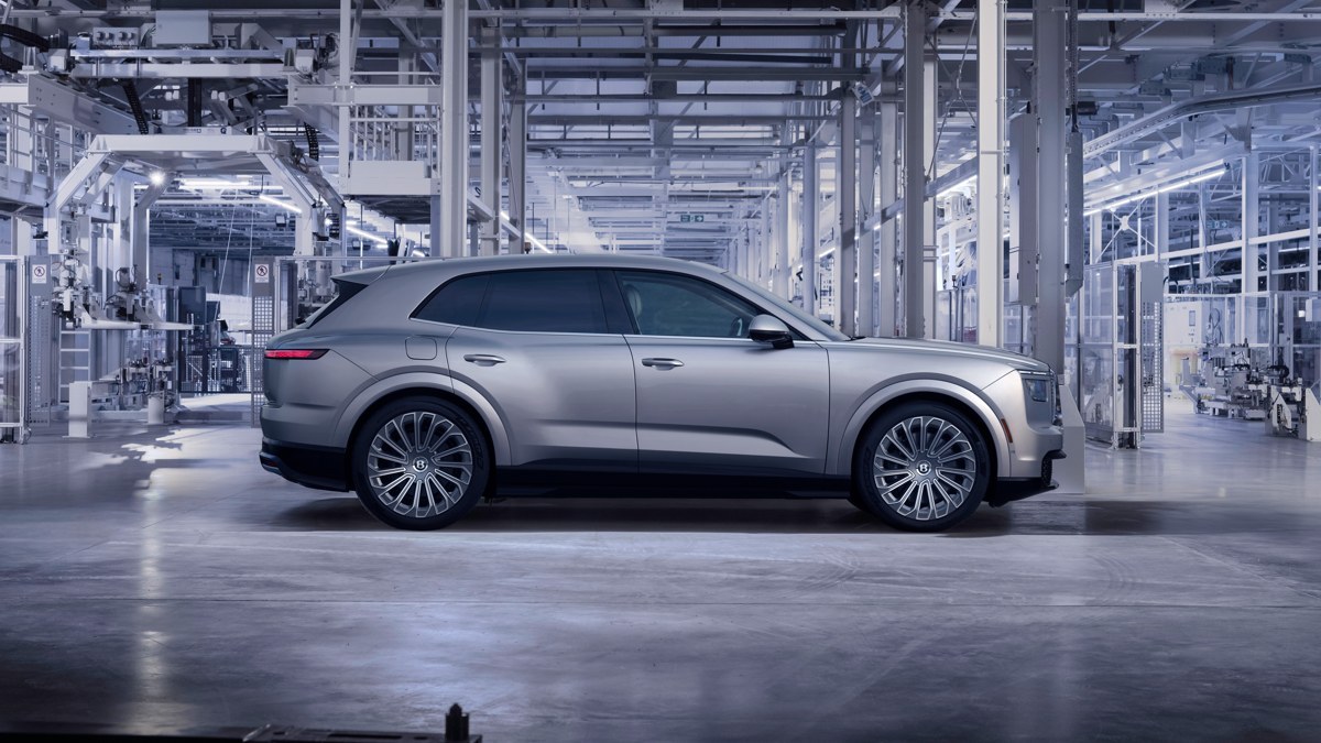 Silver Bentley Torcal parked in profile inside a factory hall